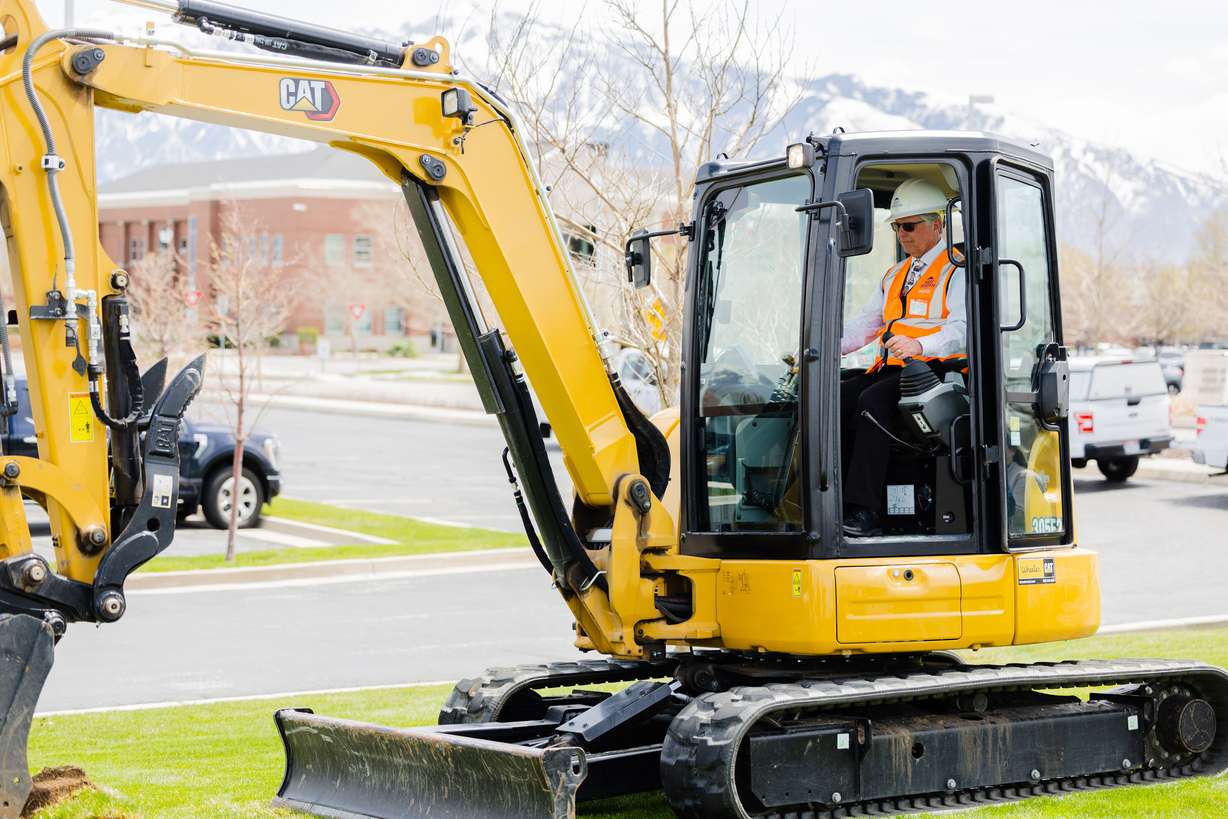West Jordan Mayor Dirk Burton operates an excavator during a press conference announcing grants for the conversion of grass fields at the West Jordan City Hall on Thursday.