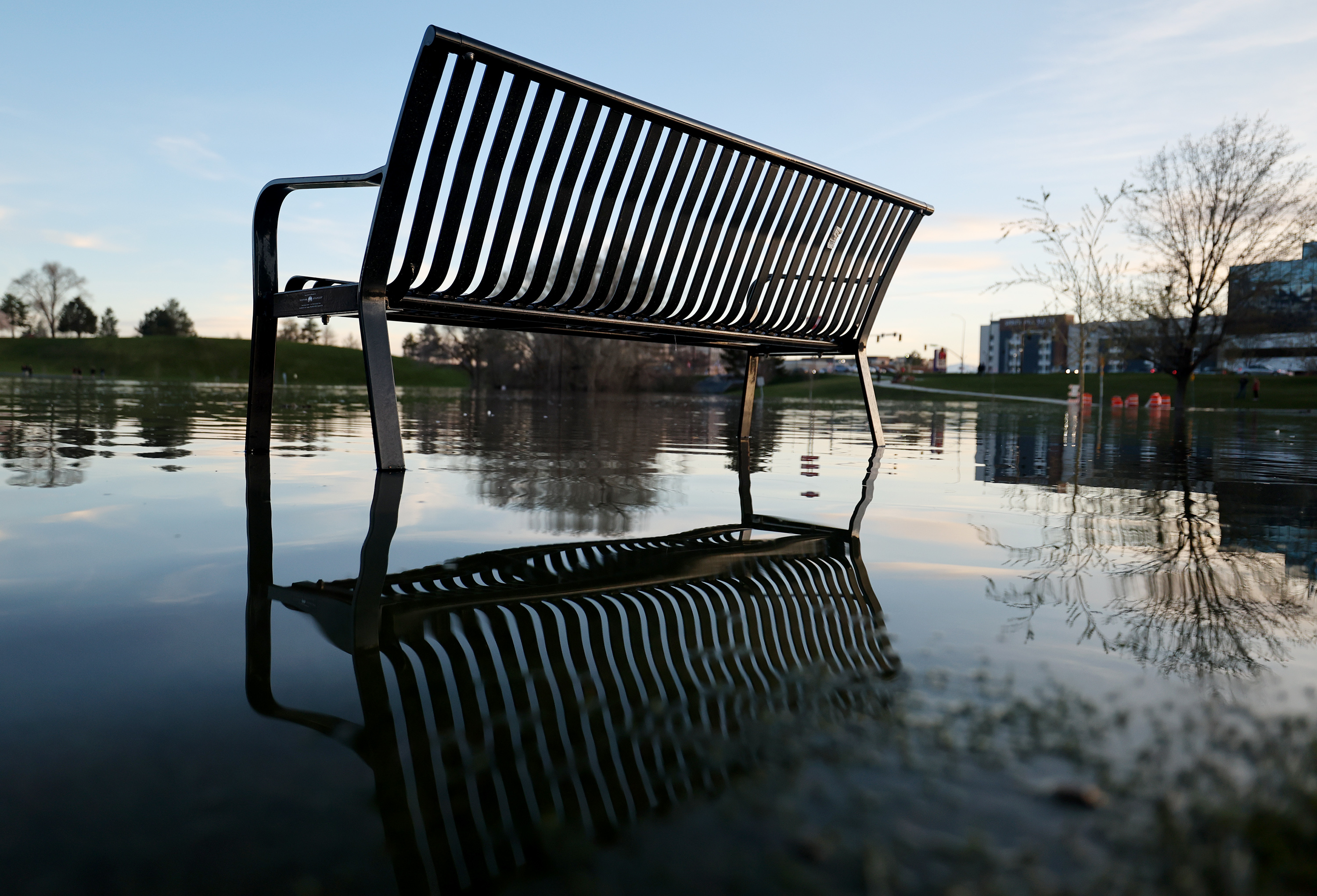 A park bench is surrounded by floodwater at Sugarhouse Park on Wednesday.