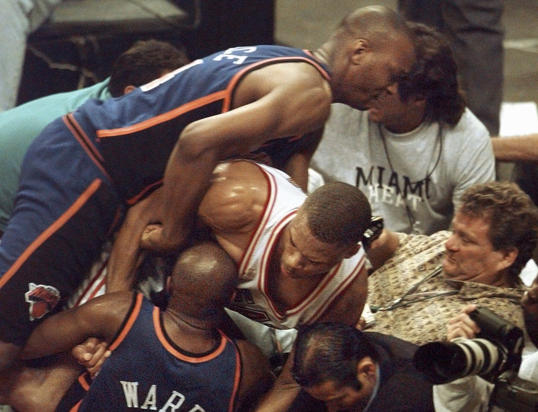 FILE - Miami Heats P.J. Brown grabs New York Knicks Charlie Ward while New York Knicks John Wallace, top, pulls on Brown during a fight in the fourth quarter Wednesday, May 14, 1997, in Miami. The Heat defeated the Knicks 96-81. The Miami Heat and New York Knicks will start the sixth edition of their playoff rivalry on Sunday, April 30, 2023, when the Eastern Conference semifinals start at Madison Square Garden.