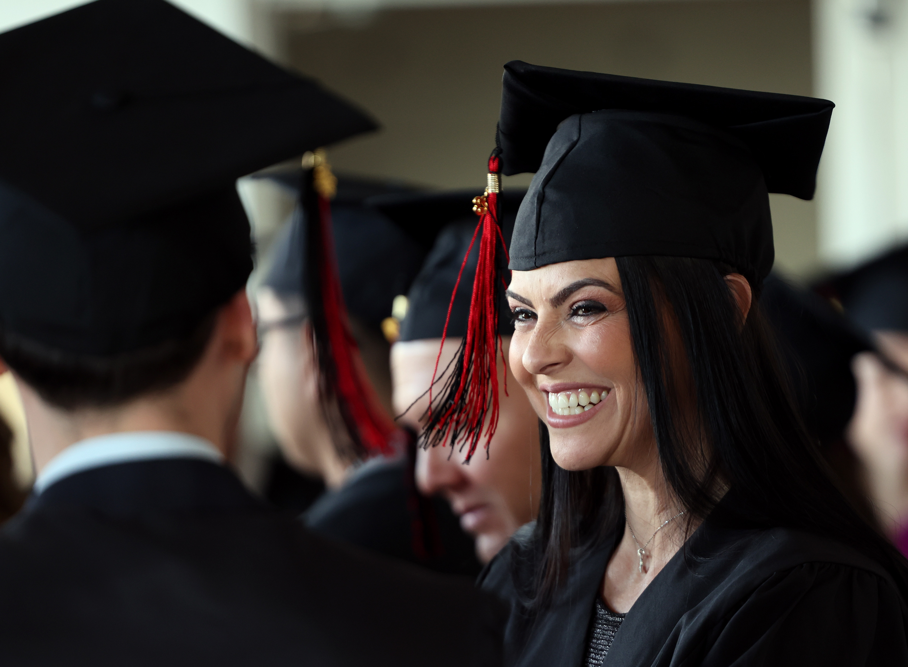 Patricia Dutra de Moraes smiles as she talks with fellow graduate Alexander Werth before receiving their certificates as the University of Utah’s English Language Institute holds the 43rd Cohort Graduation Ceremony at the Crimson View on campus in Salt Lake City on April 19.