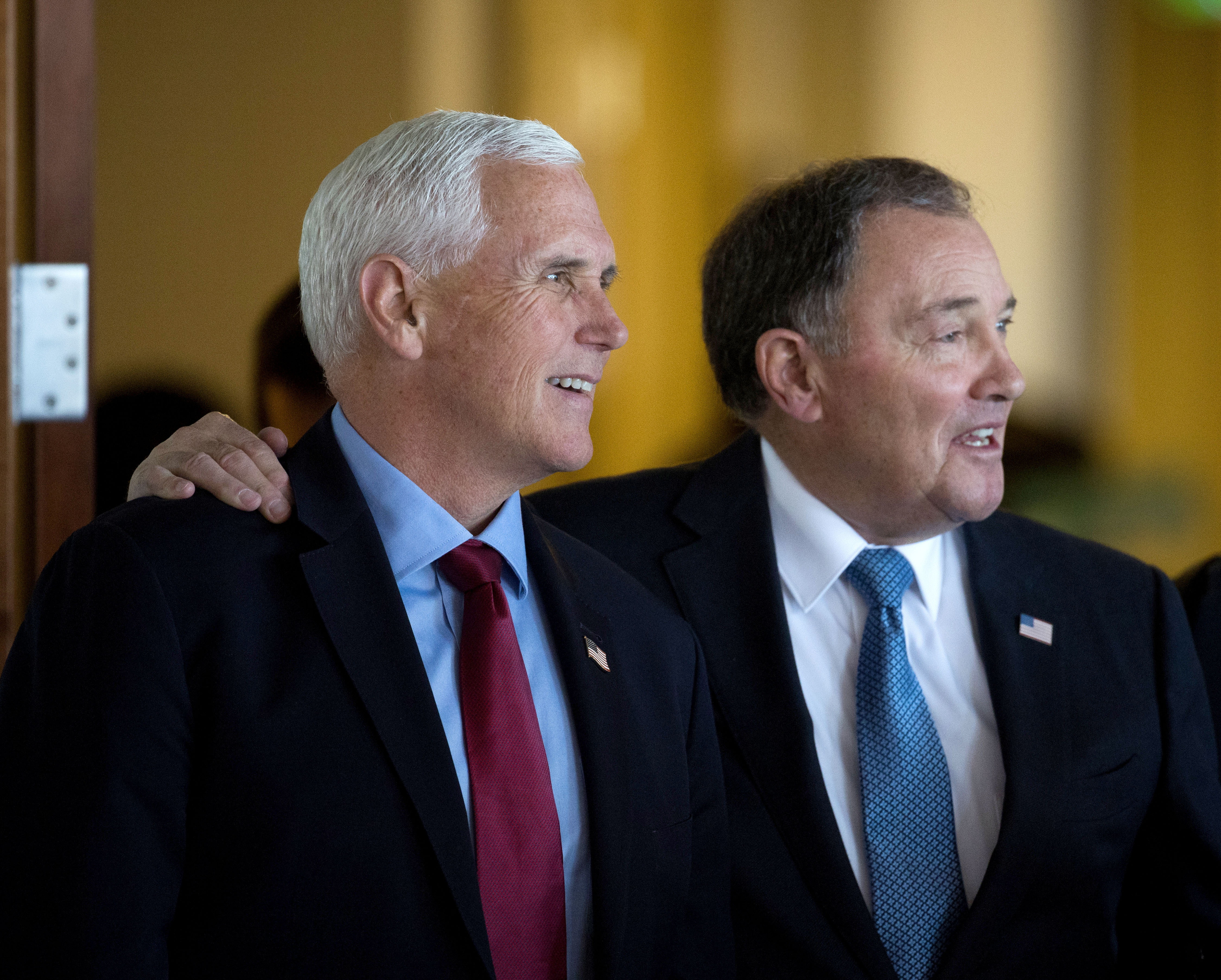 Former Vice President Mike Pence stands with former Utah Gov. Gary Herbert at a luncheon Friday.