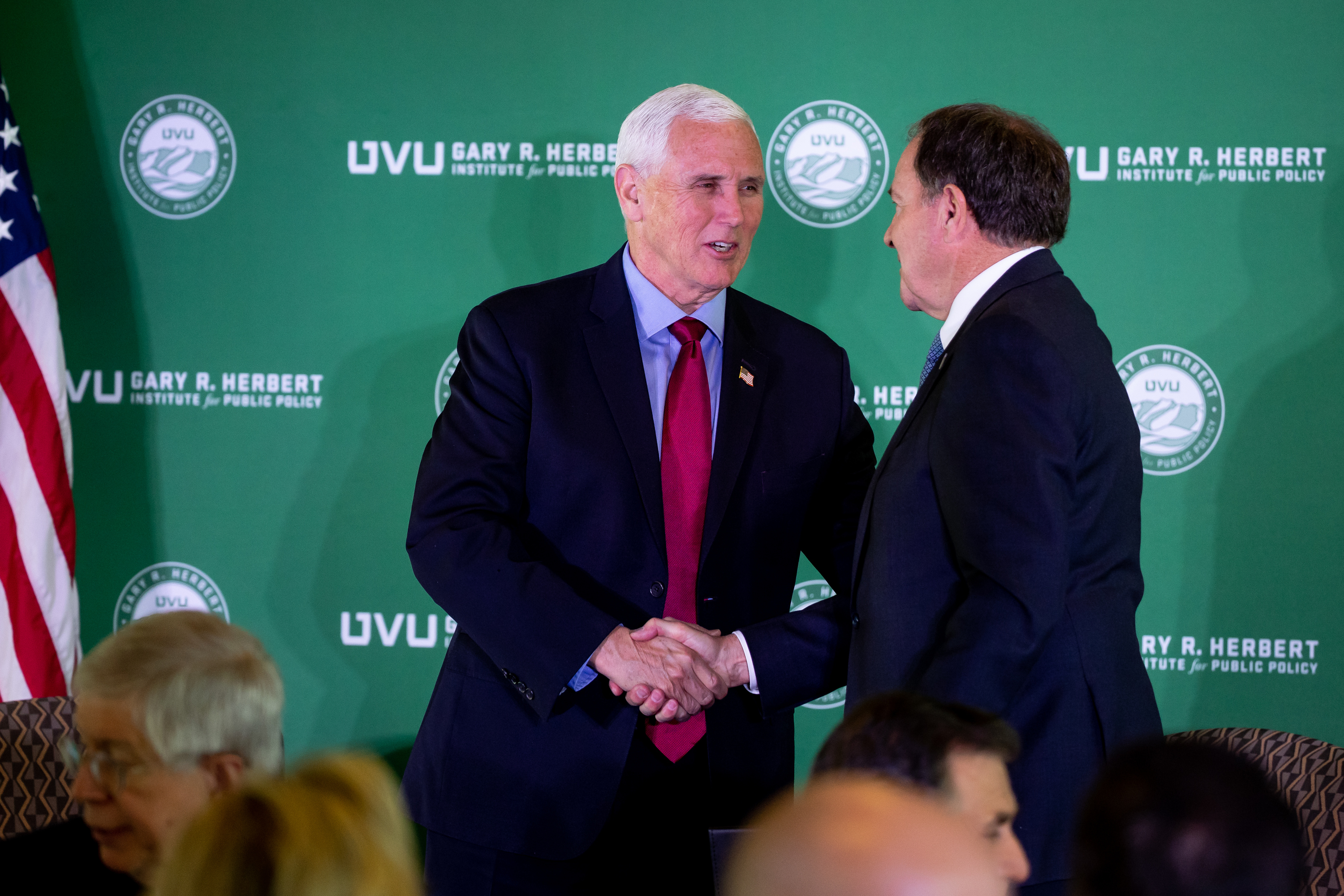 Former Vice President Mike Pence shakes hands with former Gov. Gary Herbert at an event at the Zions Bank Building in Salt Lake City on Friday.