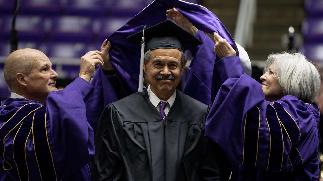 Javier Chavez Sr. receives a doctoral hood at the Weber State University commencement ceremony on Friday. Chavez was one of four individuals who were awarded doctoral degrees.