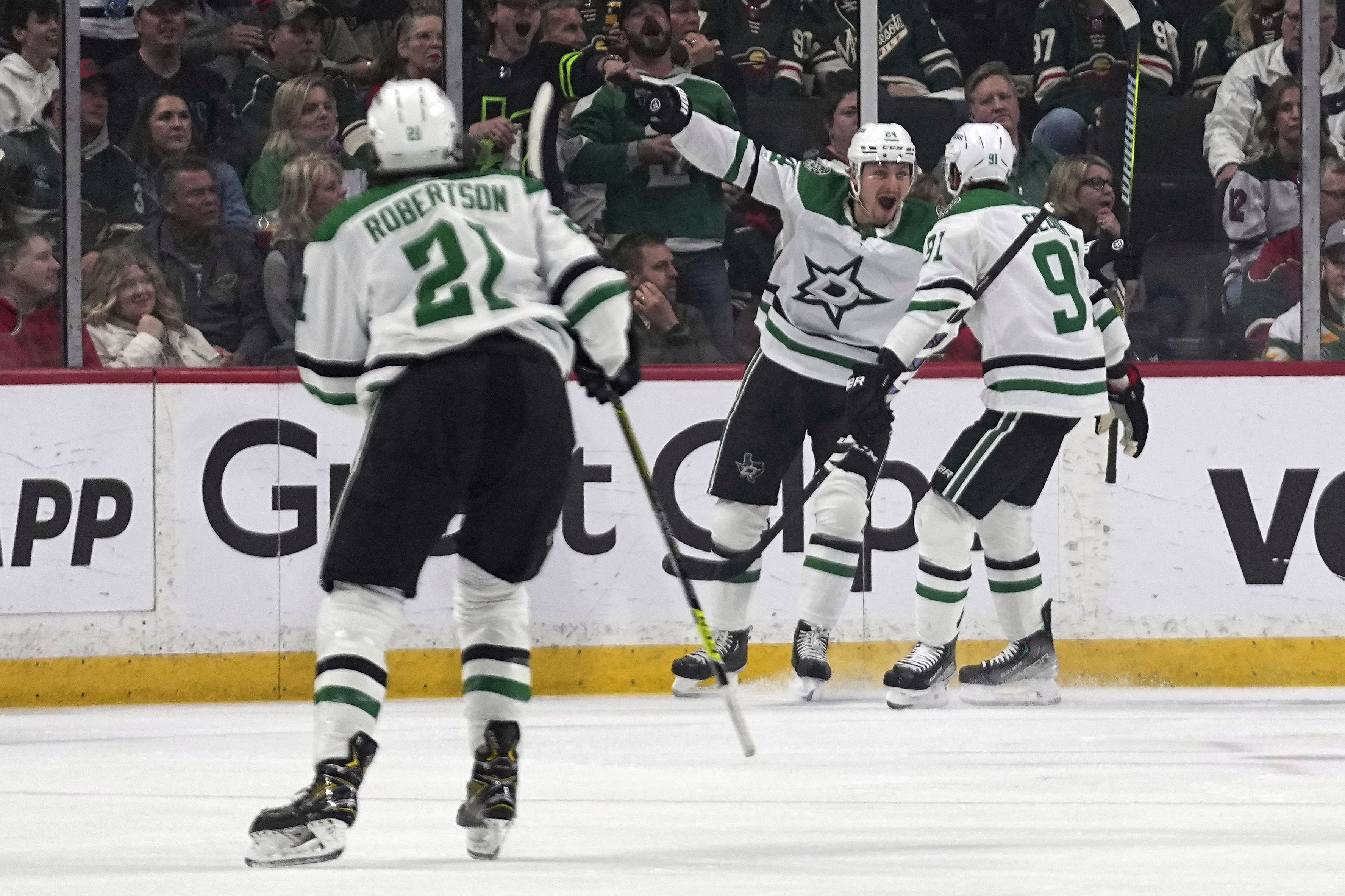Dallas Stars center Roope Hintz, center, celebrates next to center Tyler Seguin, right, after scoring during the first period of Game 6 of an NHL hockey Stanley Cup first-round playoff series against the Minnesota Wild, Friday, April 28, 2023, in St. Paul, Minn. 
