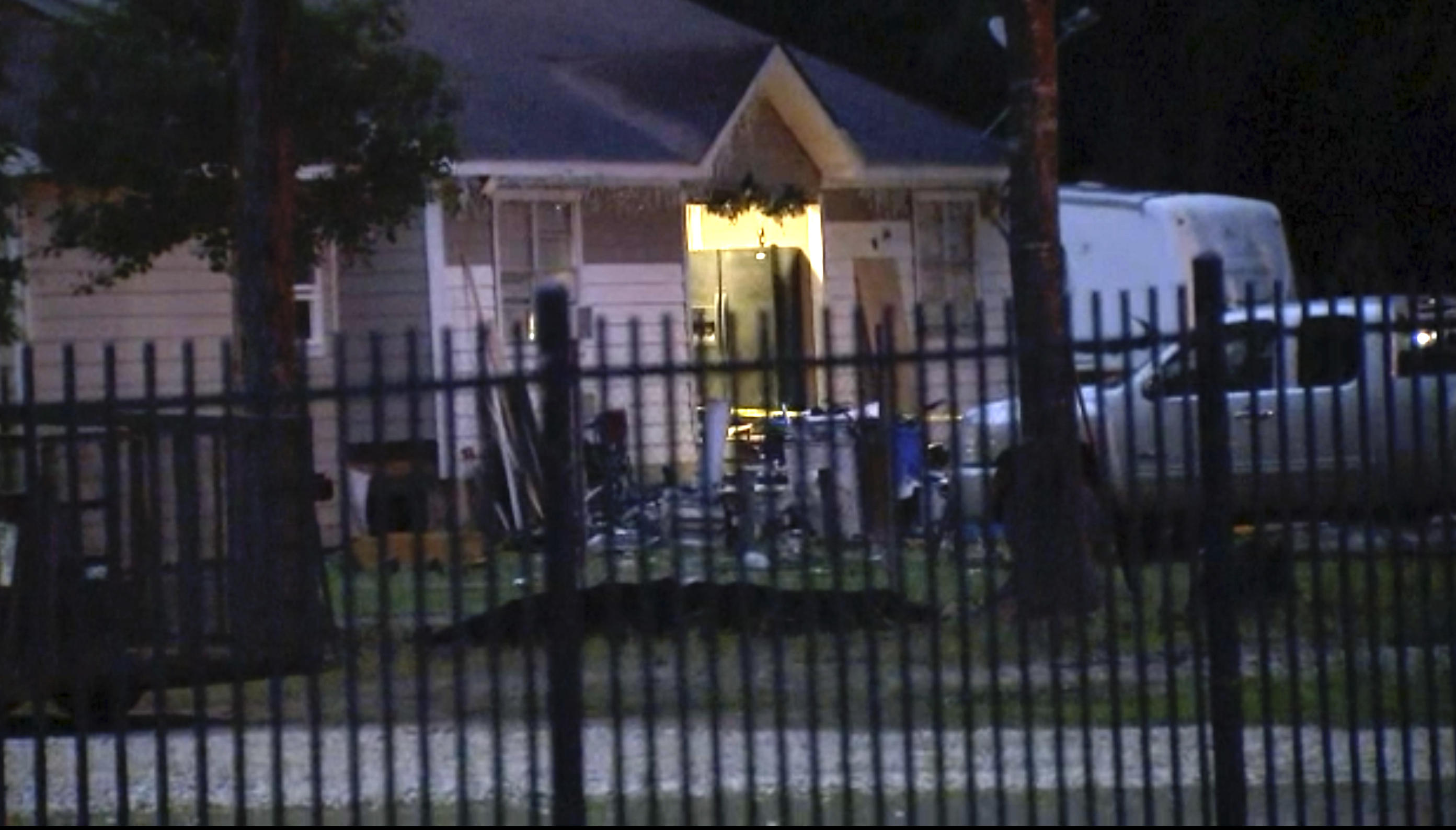 The scene of a shooting is seen early Saturday in Cleveland, Texas. A man went next door with a rifle and began shooting his neighbors, killing several including an 8-year-old inside the house, authorities said Saturday.