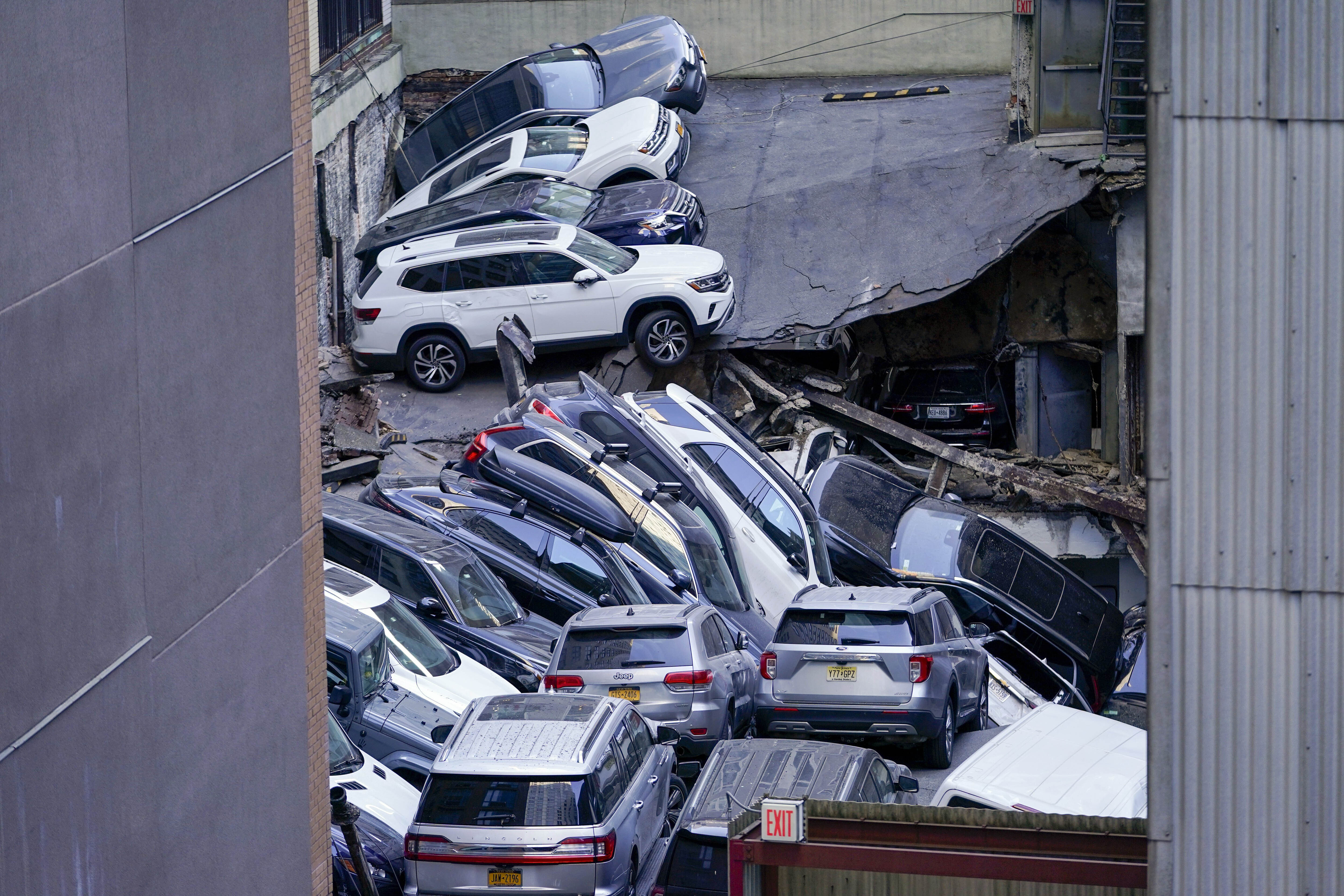 Cars are seen piled on top of each other at the scene of a partial collapse of a parking garage in the Financial District of New York, April 18 in New York. City building officials swept through dozens of parking garages and ordered four of them to immediately shutter.