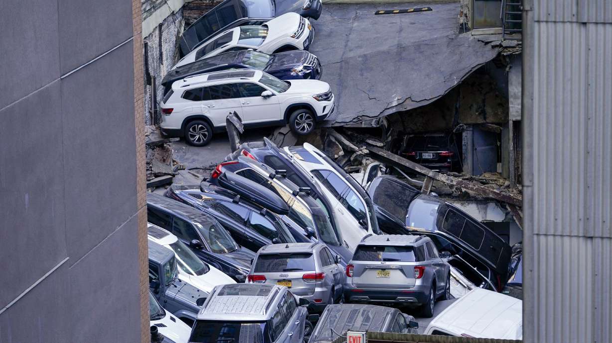 Cars are seen piled on top of each other at the scene of a partial collapse of a parking garage in the Financial District of New York, April 18 in New York. City building officials swept through dozens of parking garages and ordered four of them to immediately shutter.