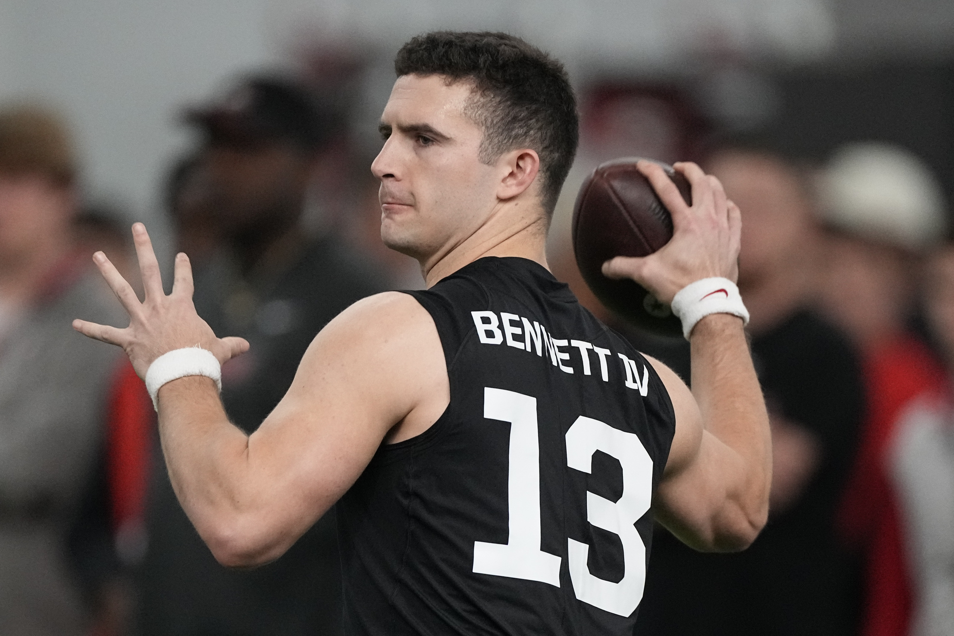 FILE - Former Georgia quarterback Stetson Bennett throws during drills at Georgia football Pro Day, Wednesday, March 15, 2023, in Athens, Ga. In the first nine drafts after former sixth-round pick Tom Brady won his first Super Bowl following the 2002 season, there were an average of seven QBs taken in the final three rounds of the draft. 