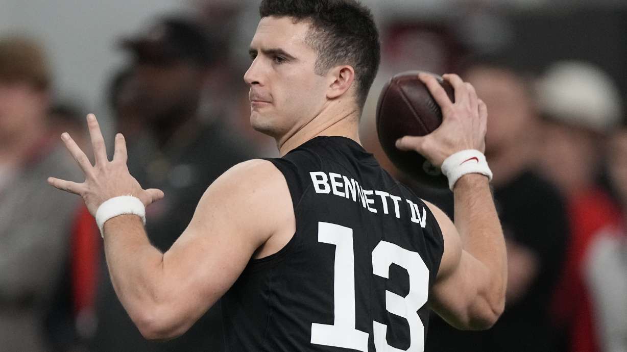FILE - Former Georgia quarterback Stetson Bennett throws during drills at Georgia football Pro Day, Wednesday, March 15, 2023, in Athens, Ga. In the first nine drafts after former sixth-round pick Tom Brady won his first Super Bowl following the 2002 season, there were an average of seven QBs taken in the final three rounds of the draft.