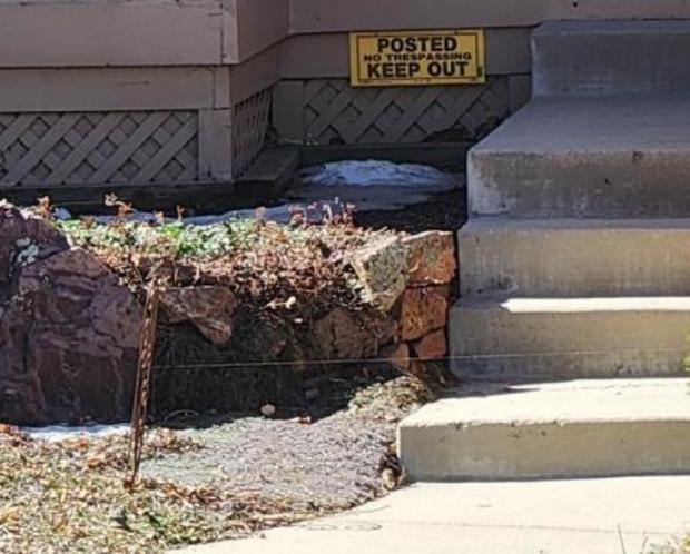 A photo shows a wire suspended across a walkway at a Highlands Ranch home. A door-to-door salesman was reportedly injured by the "booby trap" device, officials say.