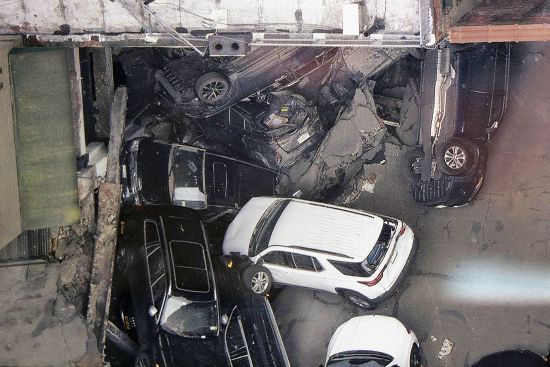 Cars are seen at the partial collapse of a parking garage in the Financial District of New York, April 19 in New York.