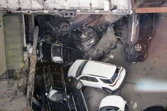 Cars are seen at the partial collapse of a parking garage in the Financial District of New York, April 19 in New York.