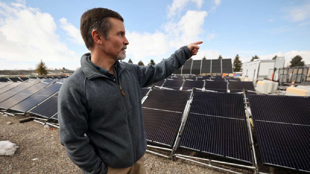 Kurt Myers, of Idaho National Laboratory, shows a microgrid outside of the INL Energy Systems Laboratory in Idaho Falls, Idaho, on April 5. The “grid-in-a-box” has solar panels that can be set up anywhere.