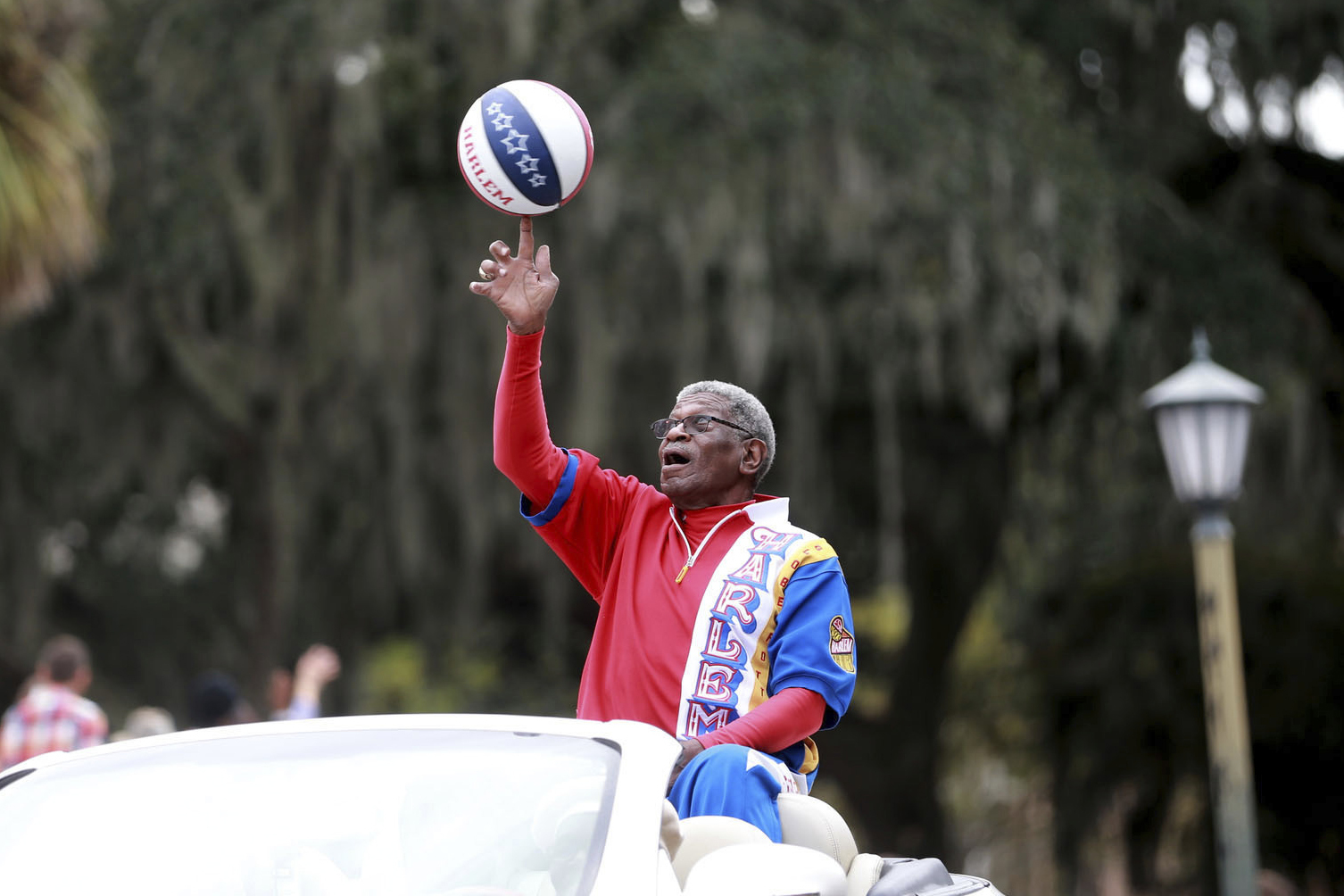 Larry "Gator" Rivers, a member of the Chatham County Commission and a former Harlem Globetrotter, shows off his ball handling skills as he rides in the annual Veterans Day Parade on Thursday, Nov. 11, 2021 in Savannah, Ga. Rivers, who helped integrate high school basketball in Georgia before playing for the Harlem Globetrotters and becoming a county commissioner in his native Savannah, died Saturday, April 29, 2023, at age 73. 