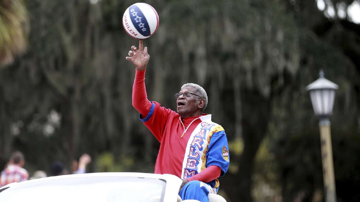 Larry "Gator" Rivers, a member of the Chatham County Commission and a former Harlem Globetrotter, shows off his ball handling skills as he rides in the annual Veterans Day Parade on Thursday, Nov. 11, 2021 in Savannah, Ga. Rivers, who helped integrate high school basketball in Georgia before playing for the Harlem Globetrotters and becoming a county commissioner in his native Savannah, died Saturday, April 29, 2023, at age 73.