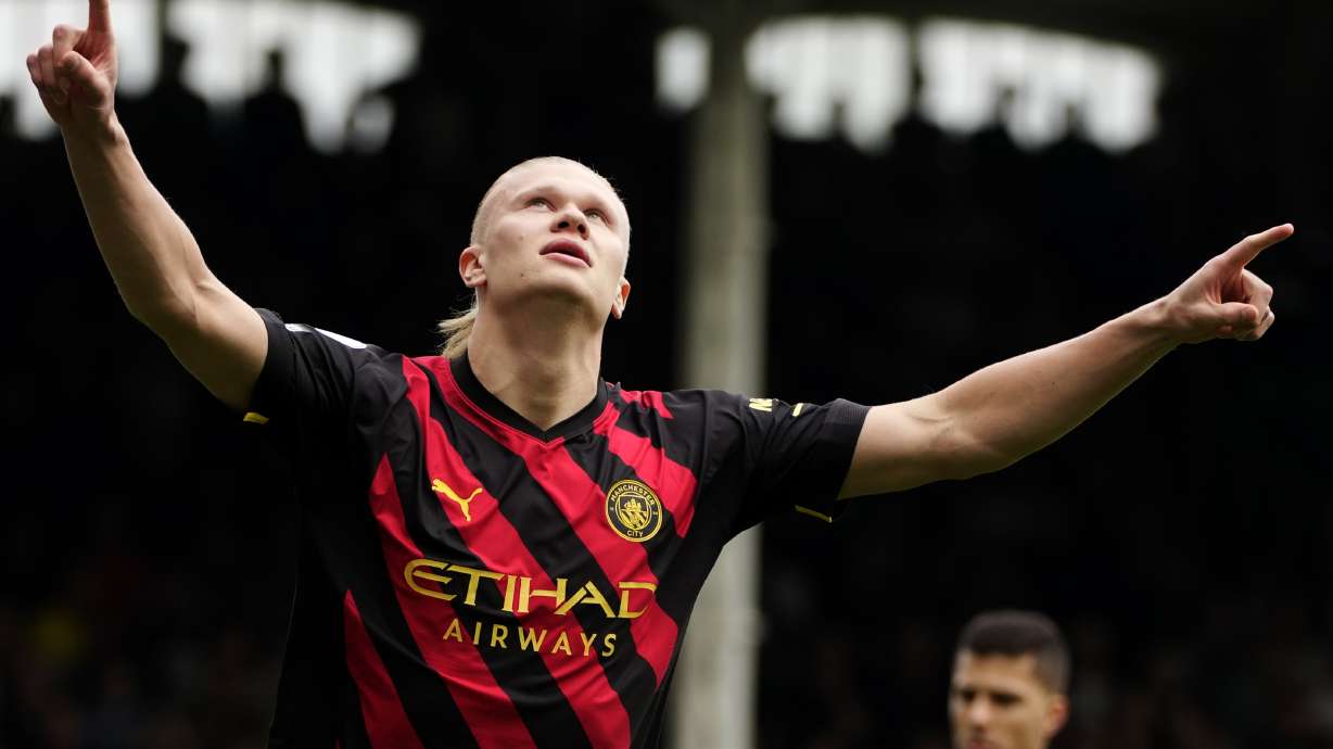 Manchester City's Erling Haaland celebrates after scoring the opening goal during the English Premier League soccer match between Fulham and Manchester City at Craven Cottage in London, Sunday, April 30, 2023.