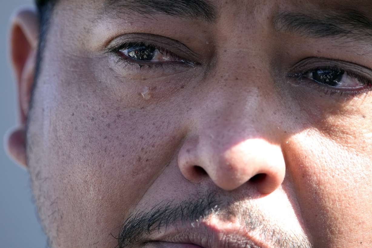 Mass shooting survivor Wilson Garcia sheds a tear as he talks about his wife and son, who were killed in Friday's shooting, Sunday at a vigil for his son in Cleveland, Texas.