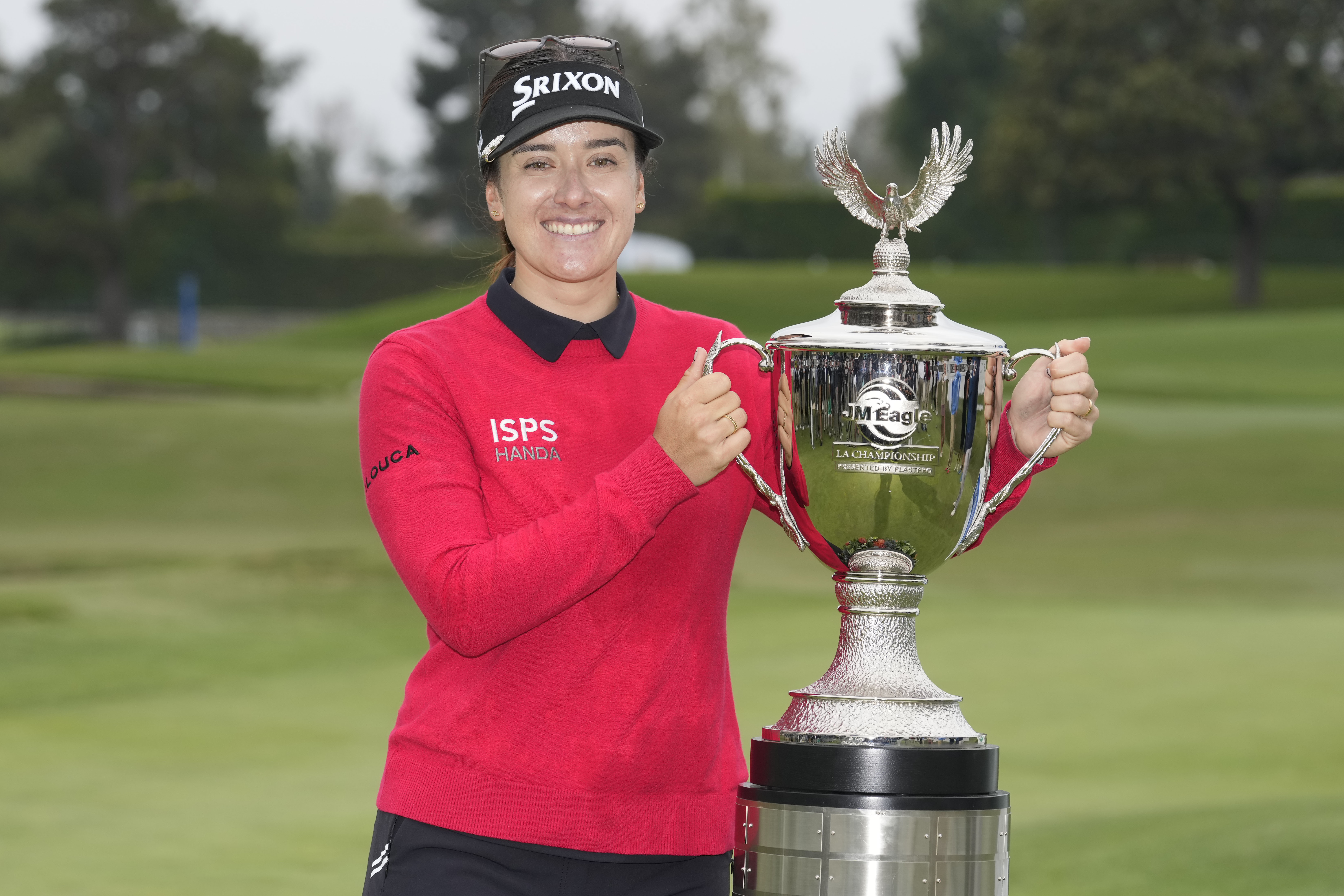 Hannah Green poses for photos with the winner's trophy after winning in a playoff in the LPGA LA Championship golf tournament at Wilshire Country Club, Sunday, April 30, 2023, in Los Angeles.