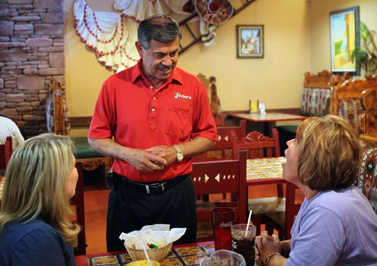 Javier Chavez Sr., owner of Javier's Authentic Mexican Food, visits with customers at one of his six restaurant locations.