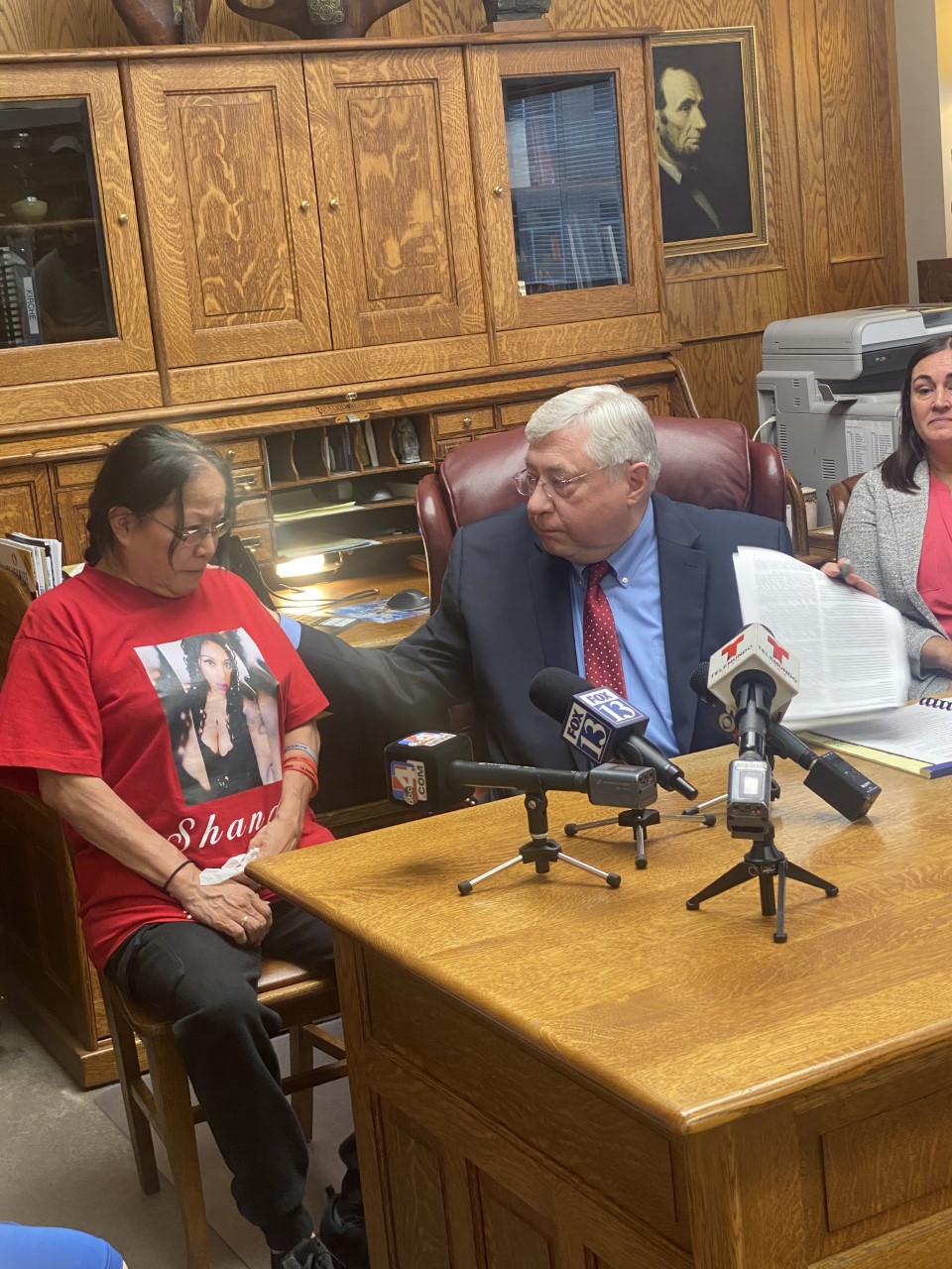 Attorney Robert Sykes comforts Marjorie Charles-Scott, the mother of Shandon Nicole Scott, who was killed two years ago Monday. Charles-Scott and others filed a lawsuit claiming violent offenders who should remain in prison were being released and not properly supervised once they were out.