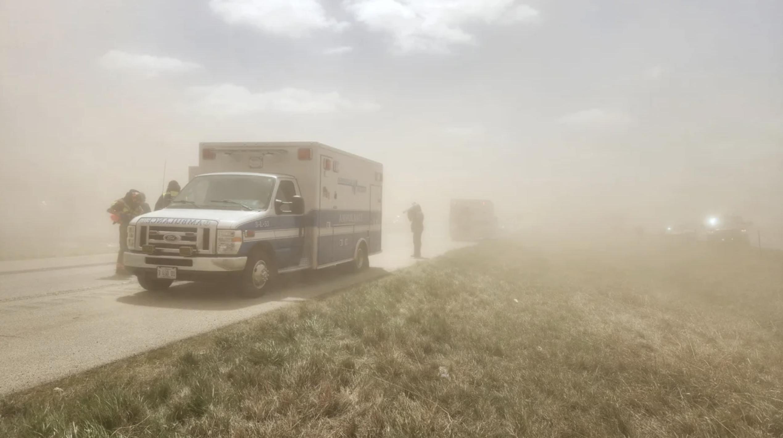 An ambulance arrives at the scene where a dust stormin Illinois caused a 40 to 60 car crash on a major highway, May 1. Authorities said there were "multiple fatalities" in the wrecks.