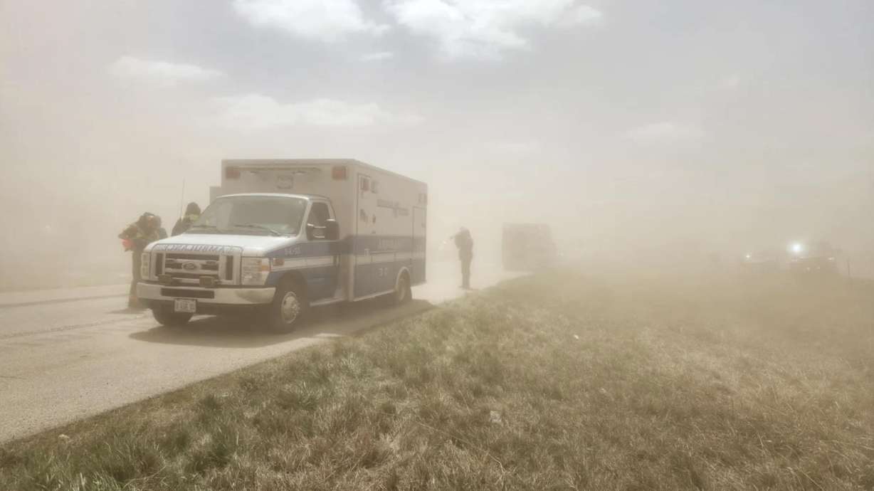 An ambulance arrives at the scene where a dust stormin Illinois caused a 40 to 60 car crash on a major highway, May 1. Authorities said there were "multiple fatalities" in the wrecks.