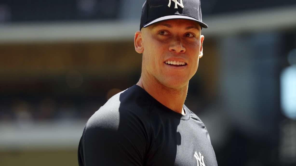 New York Yankees center fielder Aaron Judge (99) walks back to the dugout after taking a few warm up throws before a baseball game against the Texas Rangers on Sunday, April 30, 2023, in Arlington, Texas.