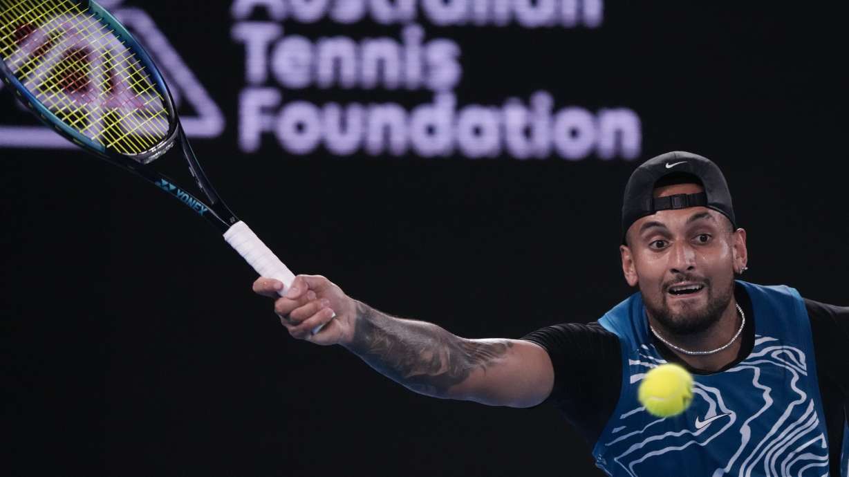 FILE - Australia's Nick Kyrgios plays a forehand return to Serbia's Novak Djokovic during an exhibition match on Rod Laver Arena ahead of the Australian Open tennis championship in Melbourne, Australia, on Jan. 13, 2023. Kyrgios has helped police Tuesday, May 1, 2023, catch a man who allegedly stole his Tesla at gunpoint from a home in Australia's capital city.