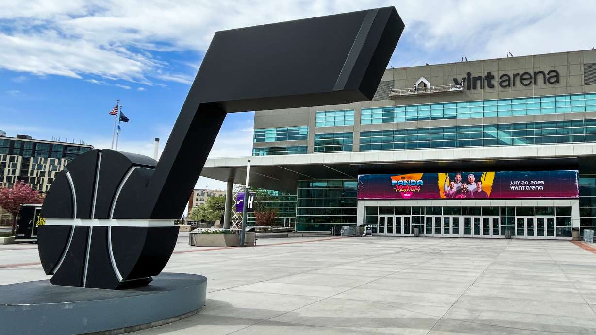 A small team removes Vivint Arena signage from the building's marquee on Tuesday. The arena, which opened in 1991, will become the Delta Center again on July 1.