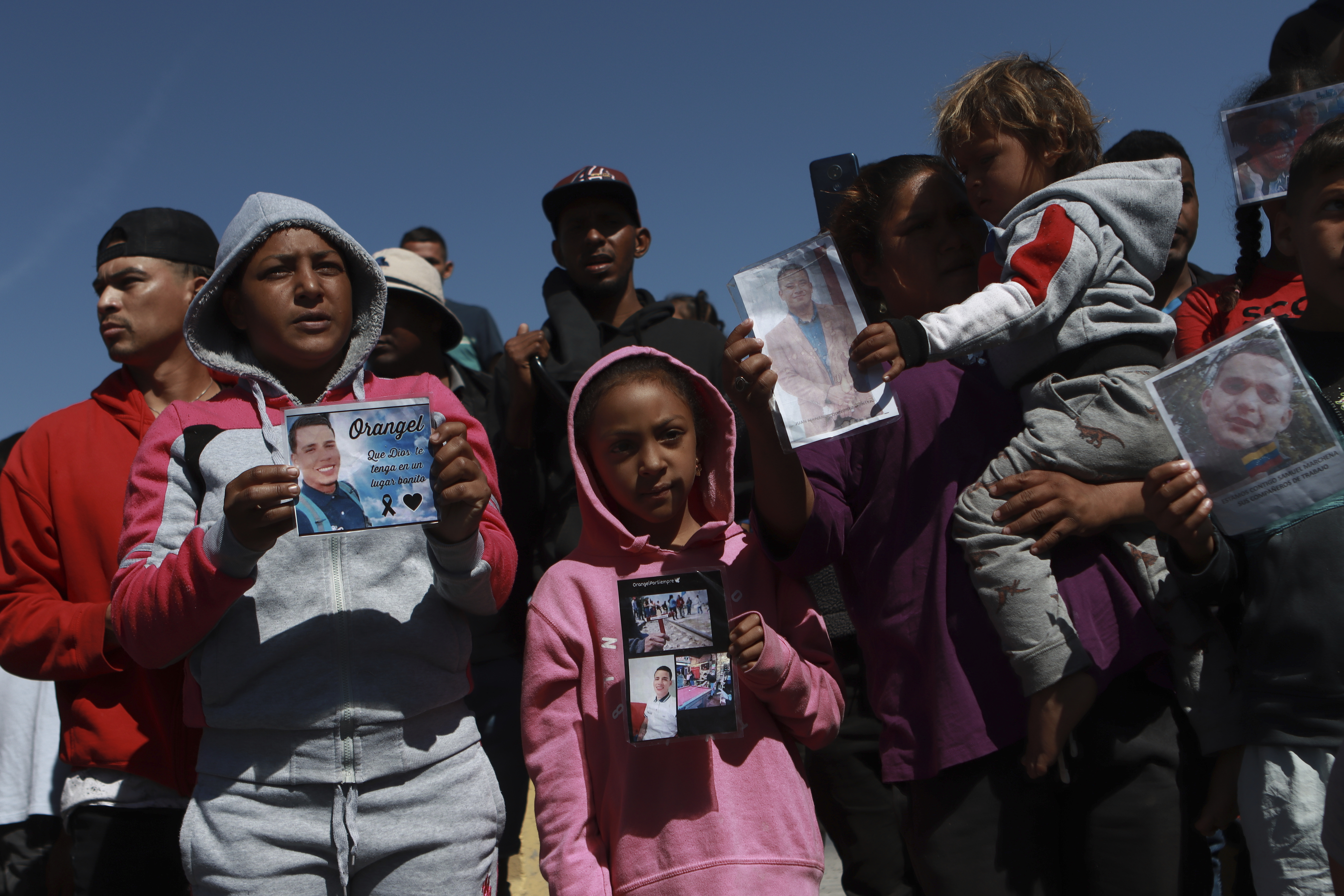 Families hold photos of migrants who died in a March 27 fire that killed 40 at an immigration detention center in Ciudad Juarez, Mexico, on April 27. Hundreds of business groups launched a campaign Monday urging Congress to take action on immigration reform.