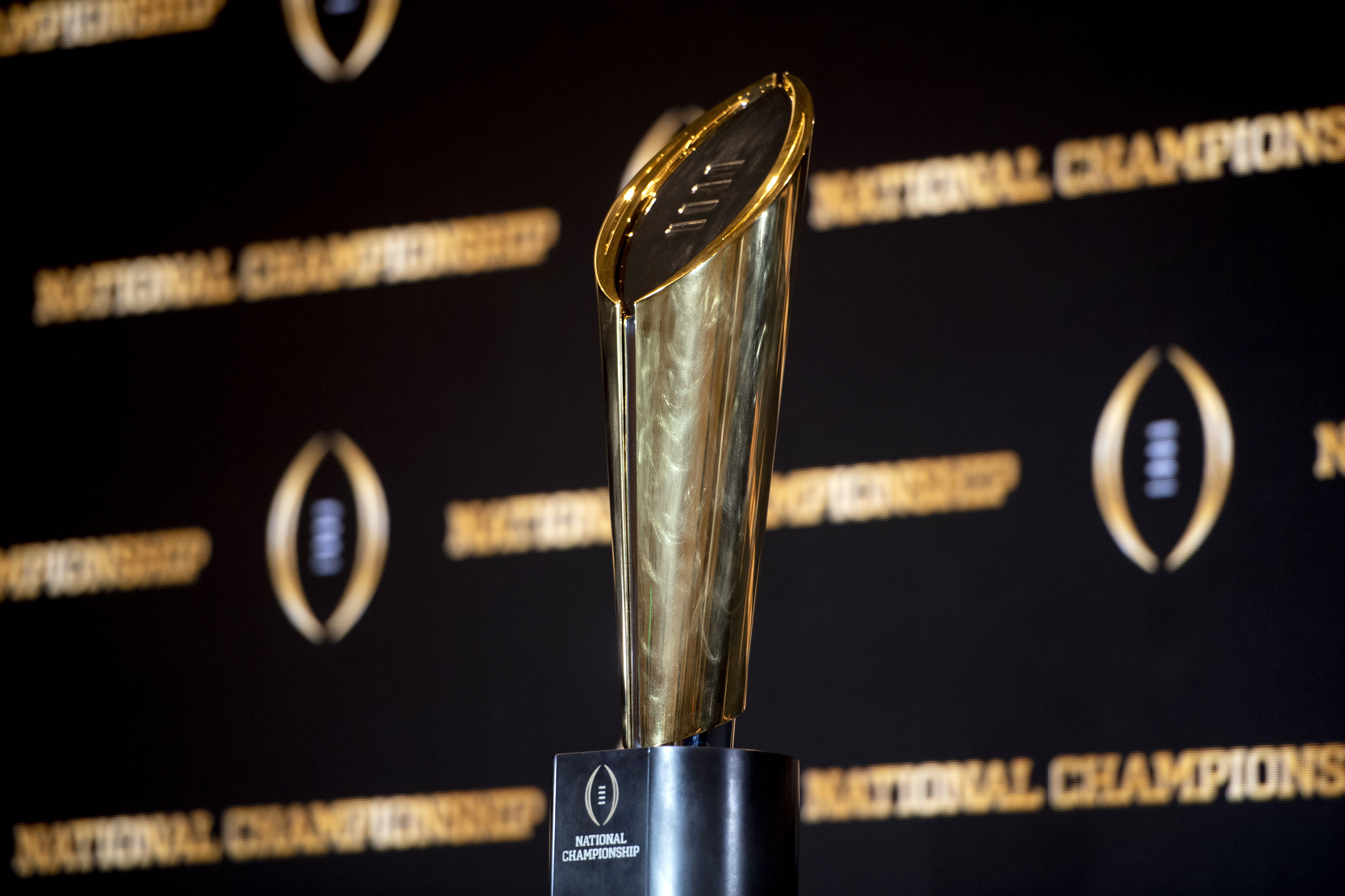FILE - The championship trophy stands on a table during a news conference ahead of the national championship NCAA College Football Playoff game between Georgia and TCU, Sunday, Jan. 8, 2023, in Los Angeles. The first-round games of the inaugural 12-team College Football Playoff will be played on Friday night and Saturday of the third week of December 2024, and the semifinals will be played in early January on weeknights to avoid conflicting with the NFL playoffs, CFP executive director Bill Hancock confirmed on Thursday, April 27, 2023. 