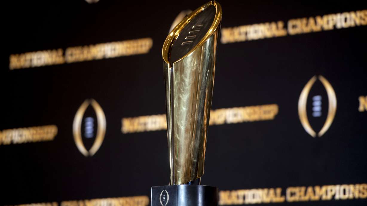 FILE - The championship trophy stands on a table during a news conference ahead of the national championship NCAA College Football Playoff game between Georgia and TCU, Sunday, Jan. 8, 2023, in Los Angeles. The first-round games of the inaugural 12-team College Football Playoff will be played on Friday night and Saturday of the third week of December 2024, and the semifinals will be played in early January on weeknights to avoid conflicting with the NFL playoffs, CFP executive director Bill Hancock confirmed on Thursday, April 27, 2023.