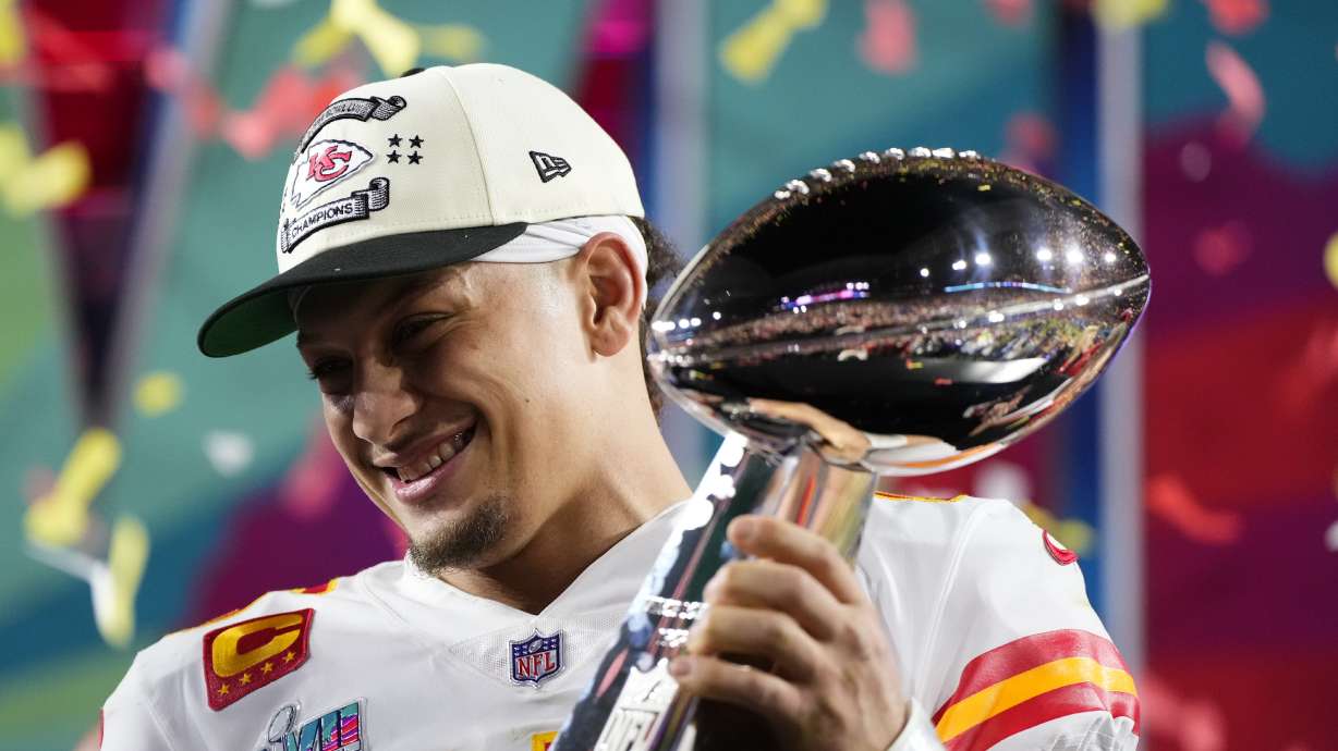 FILE -Kansas City Chiefs quarterback Patrick Mahomes (15) holds the trophy after their win against the Philadelphia Eagles in the NFL Super Bowl 57 football game, Sunday, Feb. 12, 2023, in Glendale, Ariz. For every example such as Kansas City's move to trade up for two-time MVP Patrick Mahomes in 2017 or Buffalo's decision the next year to move up for franchise quarterback Josh Allen, there are misses.