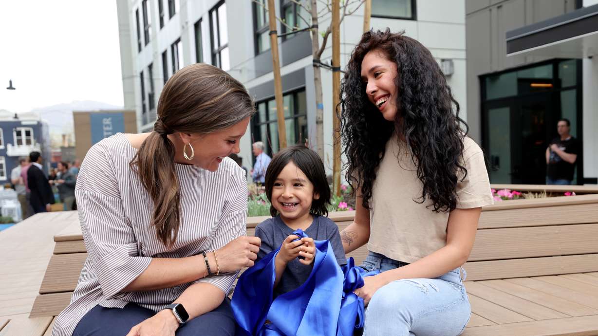 Salt Lake City Mayor Erin Mendenhall talks with James Ramirez and Stephanie Ramirez, residents of the Aster, a three-building development that includes low-income housing, commercial and public spaces in Salt Lake City on Tuesday.