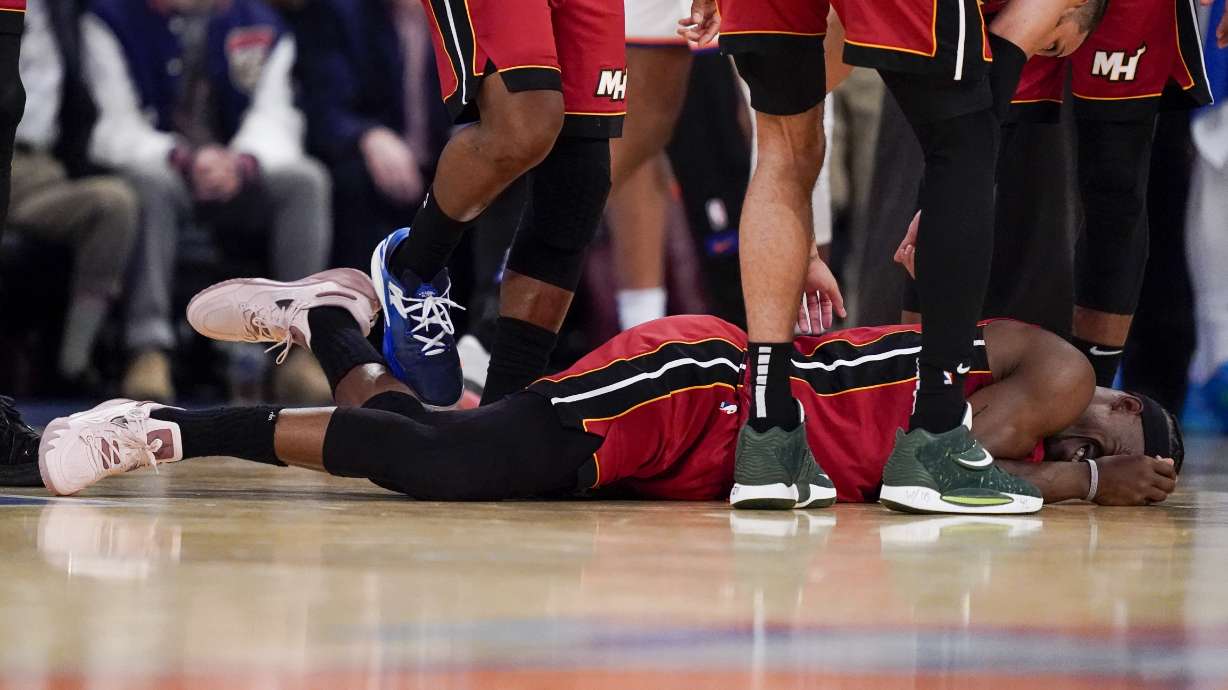 Miami Heat forward Jimmy Butler (22) lies on the court after an apparent injury during the second half of Game 1 in the NBA basketball Eastern Conference semifinals playoff series against the New York Knicks, Sunday, April 30, 2023, in New York.