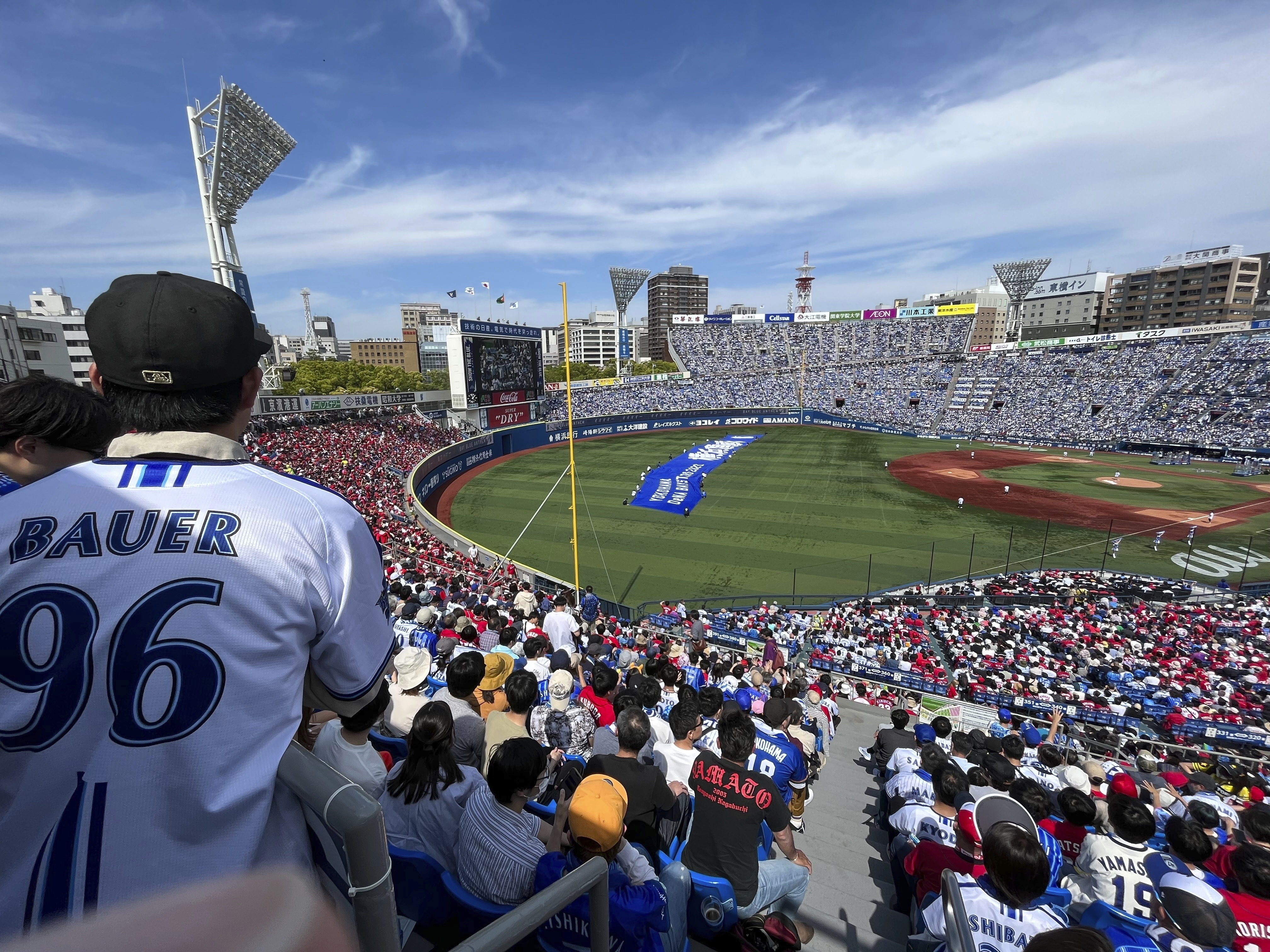 Audience members including fans wearing shirts with the name of Yokohama DeNA BayStars starting pitcher Trevor Bauer during their game against the Hiroshima Toyo Carp in Yokohama, south of Tokyo, Wednesday, May 3, 2023.