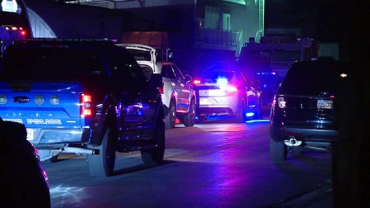 A woman was hospitalized Tuesday night after Syracuse police say she pointed a gun at officers, who shot and injured her.