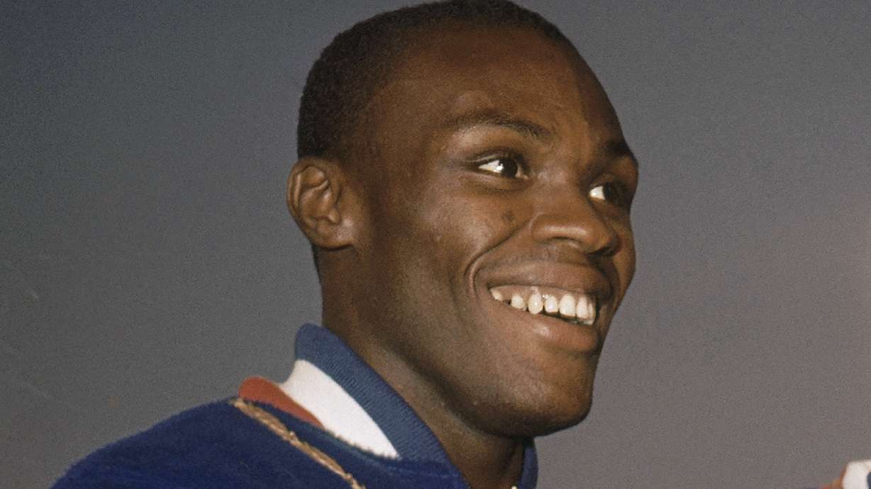FILE - Ralph Boston smiles on the podium at the Summer Olympics in Rome, Italy, Sept. 2, 1960. Ralph Boston, the Olympic long jump champion who broke Jesse Owens' record then later had his own mark eclipsed by Bob Beamon's record-shattering leap at the Mexico City Games, has died. He was 83. The U.S. Olympic and Paralympic Committee confirmed Boston died Sunday, April 30, 2023, at his home outside of Atlanta.