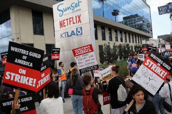Writers Guild of America members and supporters picket outside Sunset Bronson Studios and Netflix Studios, after union negotiators called a strike for film and television writers, in Los Angeles, Wednesday.