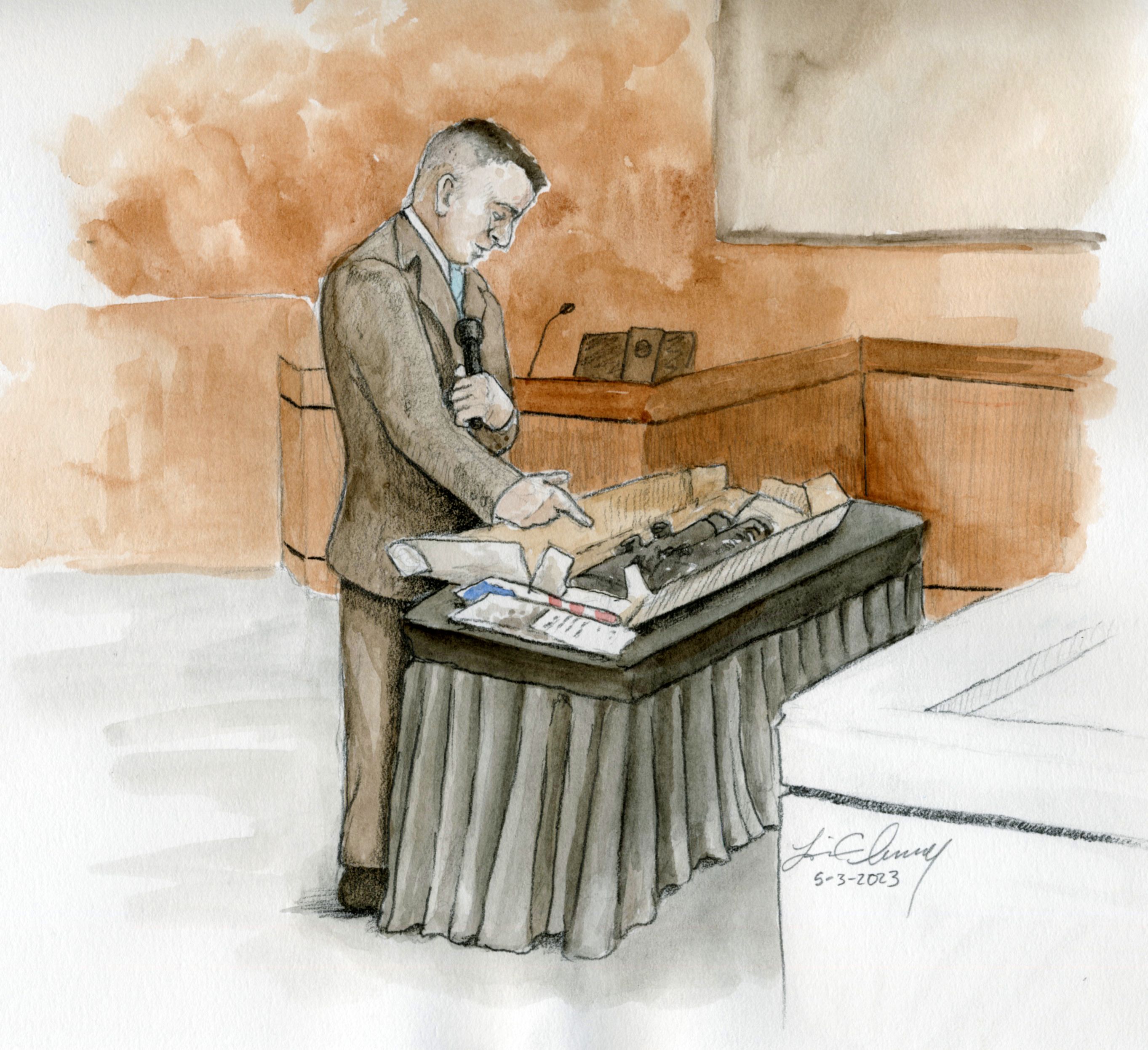 Fremont (Idaho) County sheriff's detective Vincent Kaaiakamanu shows a gun collected during a search of Alex Cox's home to the jury during the murder trial for Lori Vallow Daybell on Wednesday.