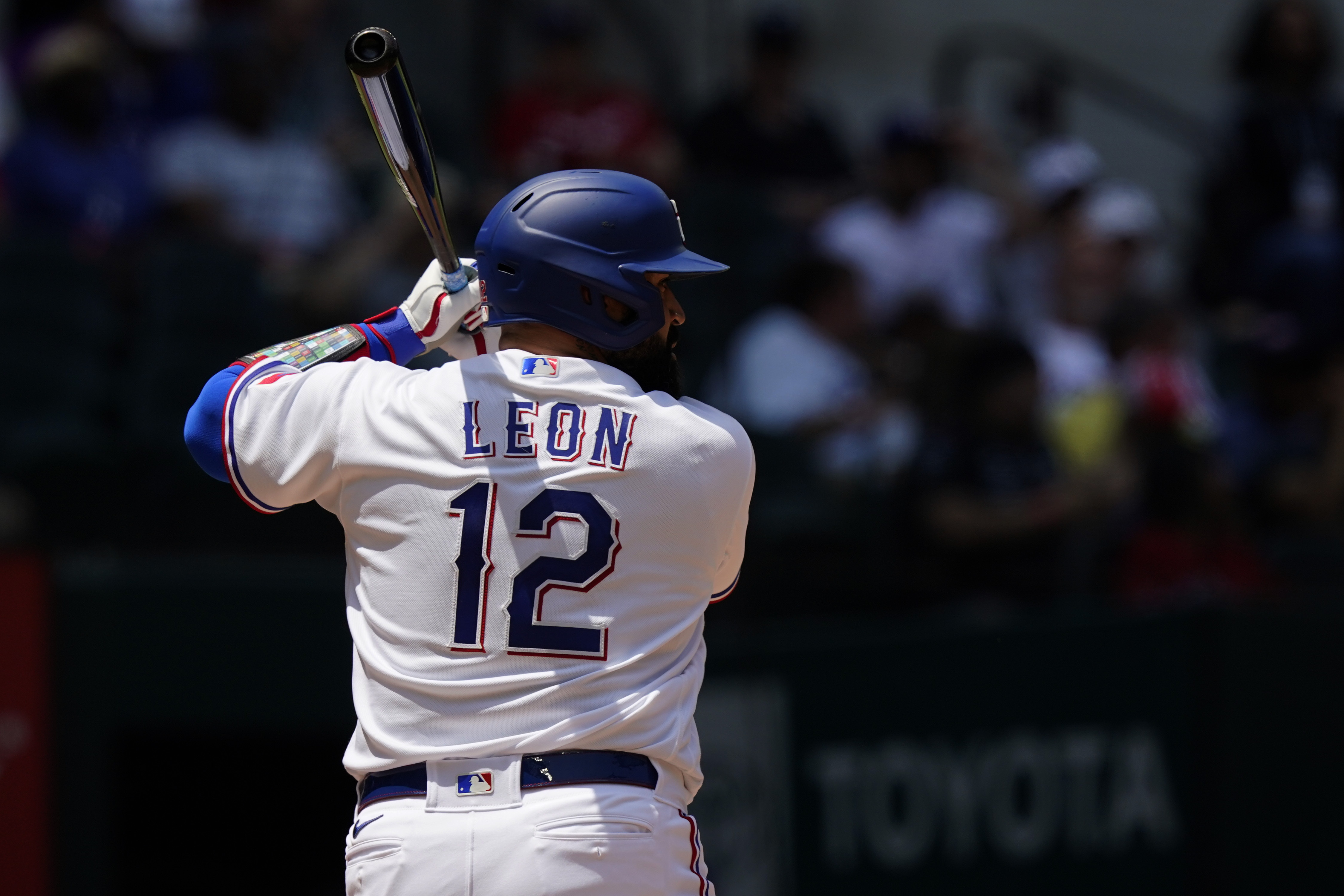 Texas Rangers' Sandy Leon (12) stands at bat during a baseball game against the Arizona Diamondbacks in Arlington, Texas, Wednesday, May 3, 2023. Veteran big league catcher Sandy León changed his uniform to No. 12 this season with the Texas Rangers to remind himself of the worst day of his life. 
