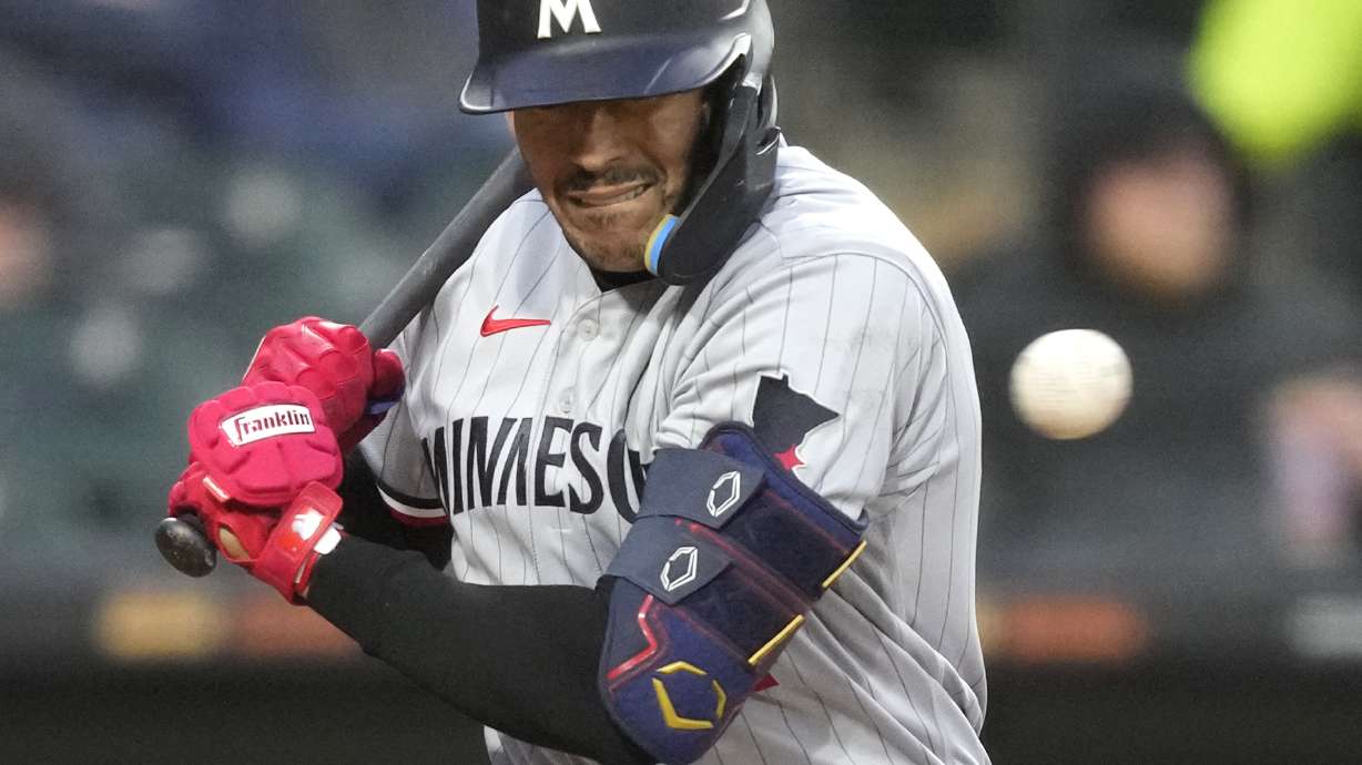 Minnesota Twins' Carlos Correa reacts to an inside pitch from Chicago White Sox's Michael Kopech during the sixth inning of a baseball game on Tuesday, May 2, 2023, in Chicago.