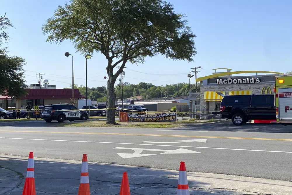 Police vehicles sit parked in front of a McDonald's restaurant as police investigate a shooting in which multiple people were killed Thursday in Moultrie, Georgia.