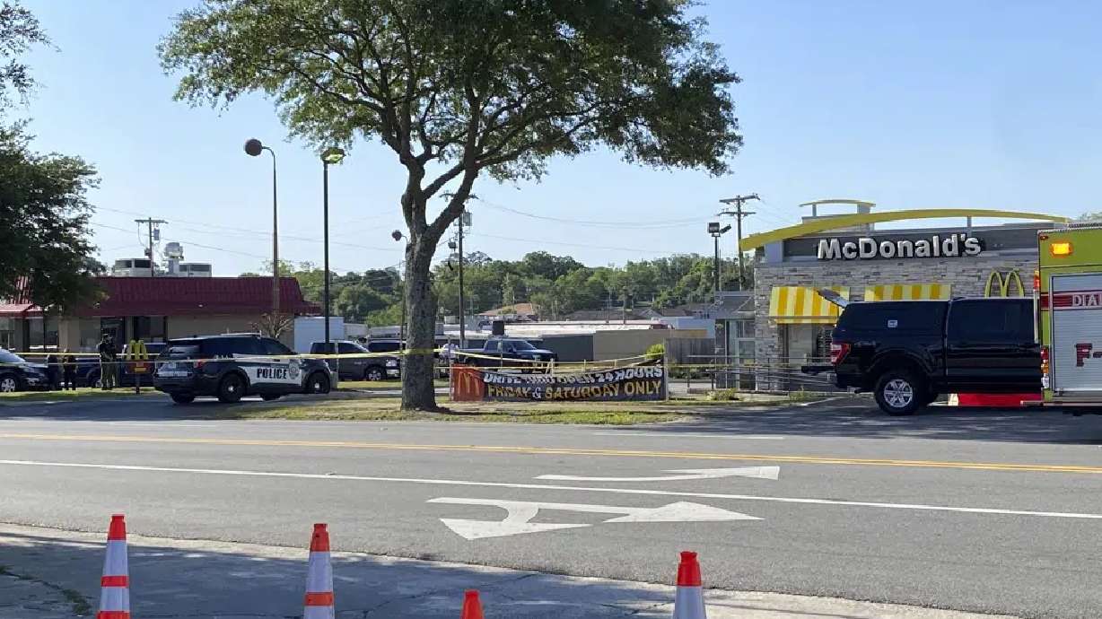 Police vehicles sit parked in front of a McDonald's restaurant as police investigate a shooting in which multiple people were killed Thursday in Moultrie, Georgia.