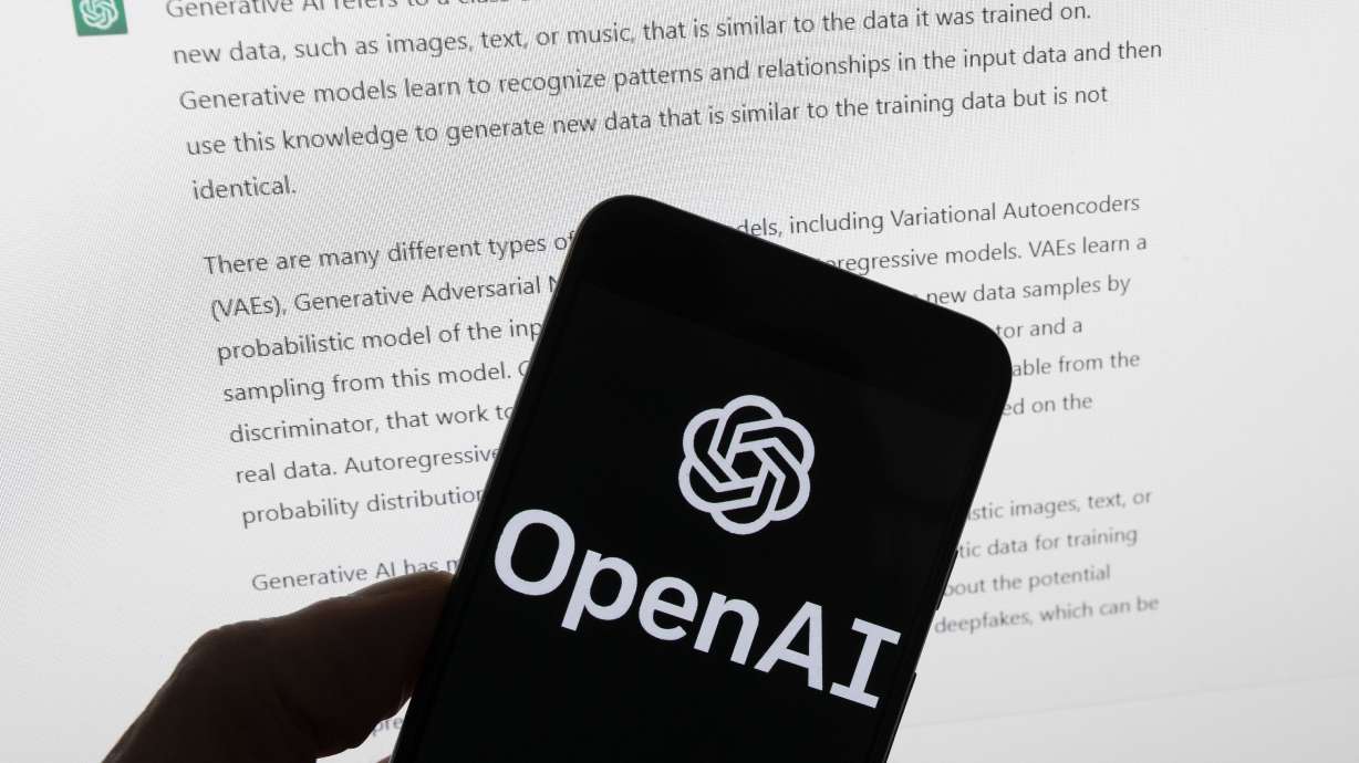 The OpenAI logo is seen on a mobile phone in front of a computer screen displaying output from ChatGPT, March 21 in Boston. Vice President Kamala Harris met with leaders from four major tech companies on Thursday to discuss issues related to emerging artificial intelligence tools.