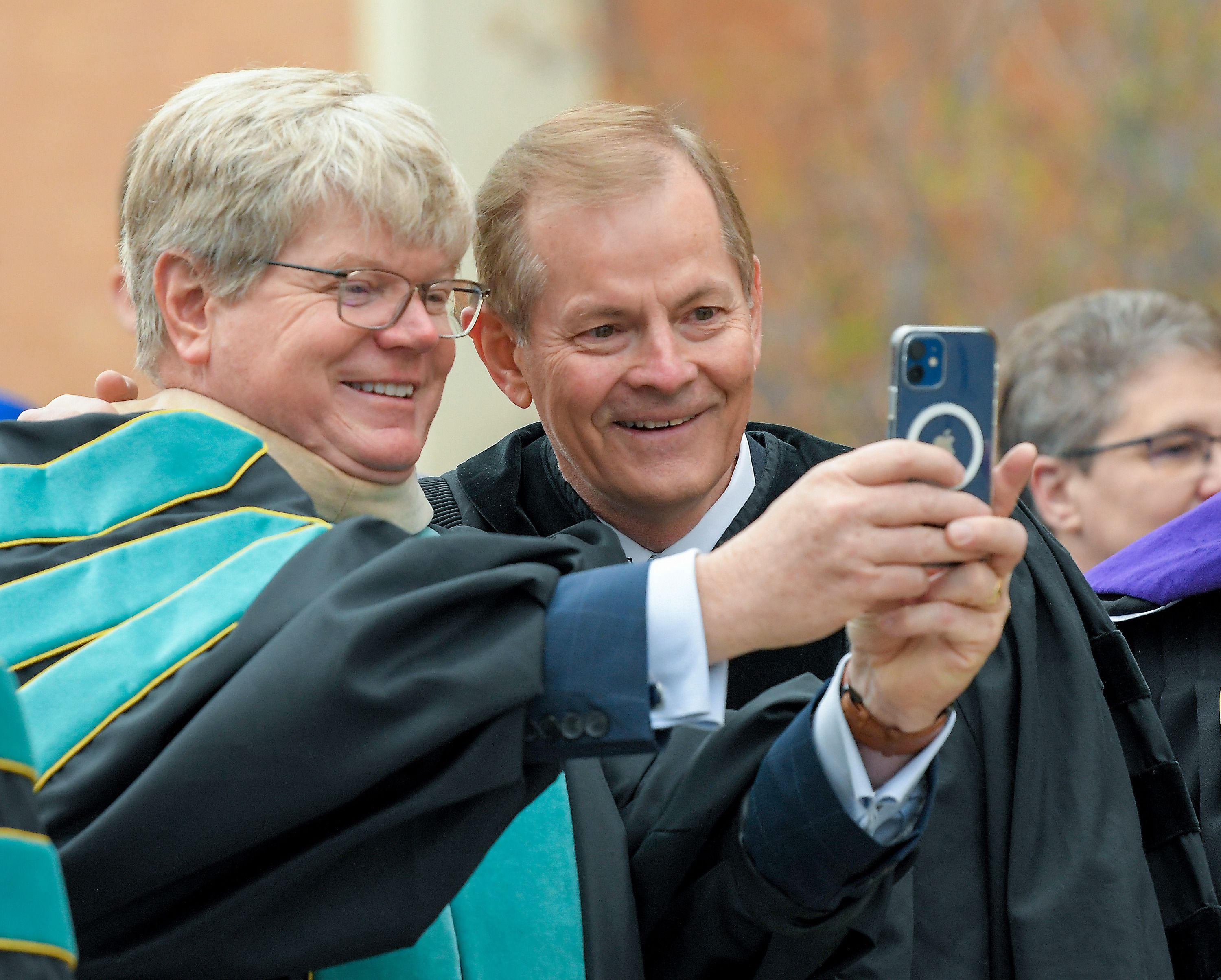 Arthur E. Newell, of the Utah Board of Higher Education, takes a photo with Elder Gary E. Stevenson during Utah State University’s commencement ceremony on Thursday in Logan.