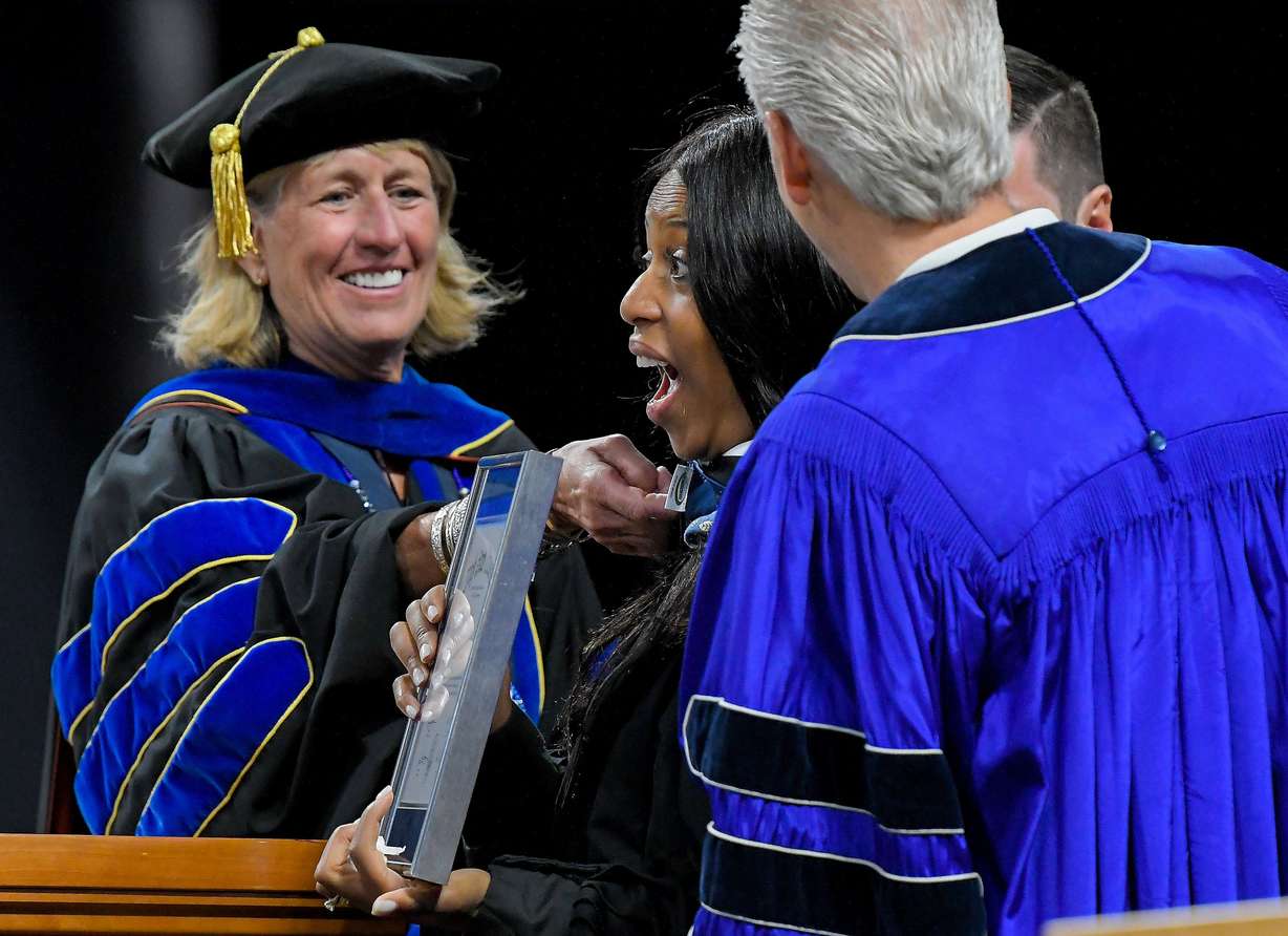 President Noelle Cockett, left, bestows an honorary degree of Humane Letters to Mia Love during Utah State University’s commencement ceremony on Thursday in Logan.