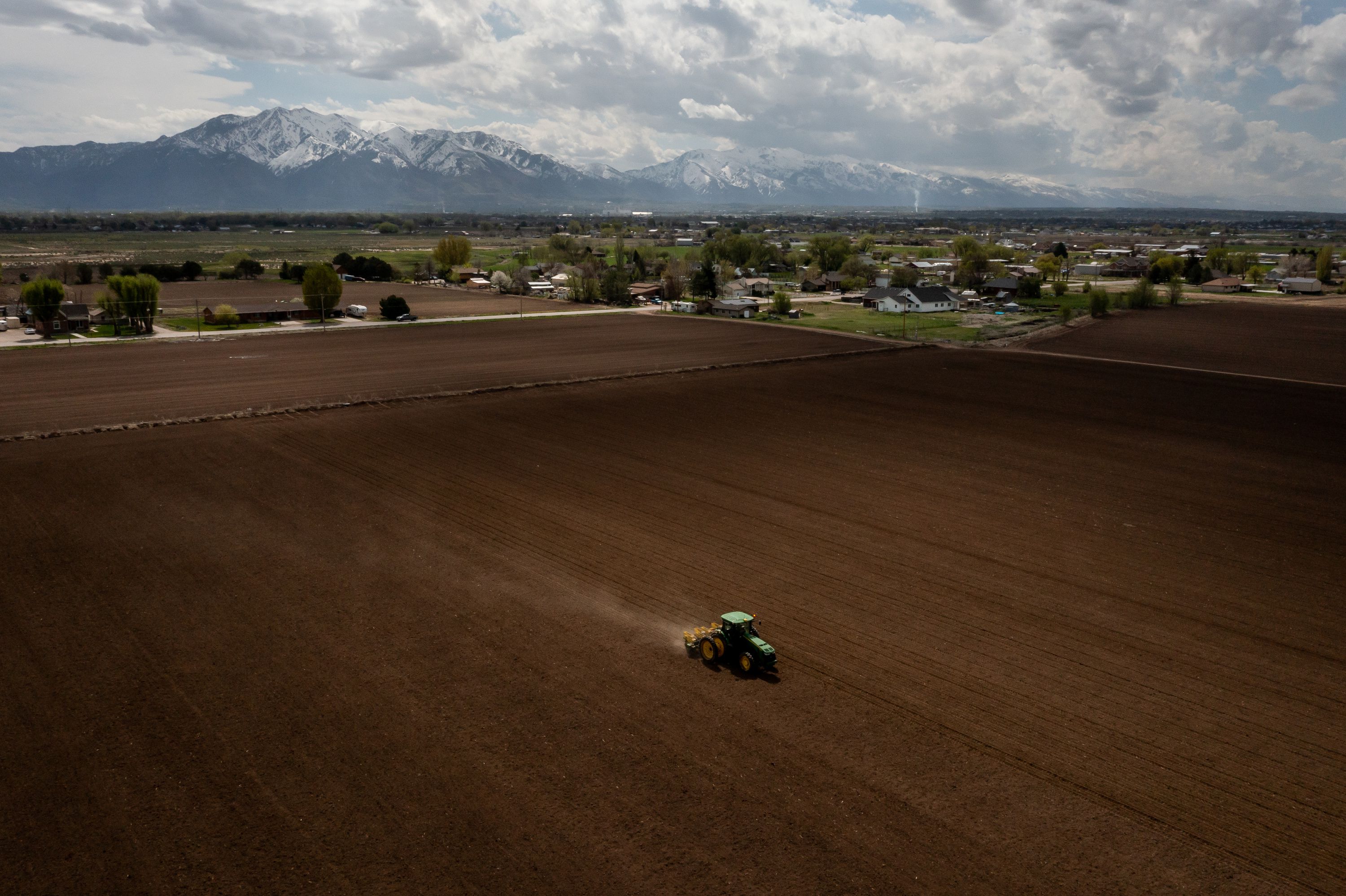 Ron Gibson, owner of Gibson’s Green Acres and president of the Utah Farm Bureau, drives a tractor while planting a field with corn in Ogden on Thursday.