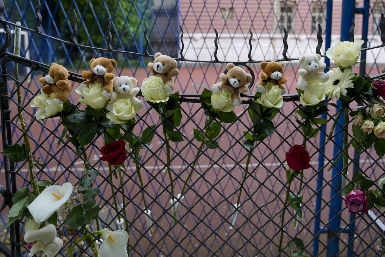 Flowers and toys are placed for the victims near the Vladislav Ribnikar school in Belgrade, Serbia, Thursday, after a 13-year-old shot and killed multiple fellow students and a guard before calling the police and being arrested. Several children and a teacher were also hospitalized.