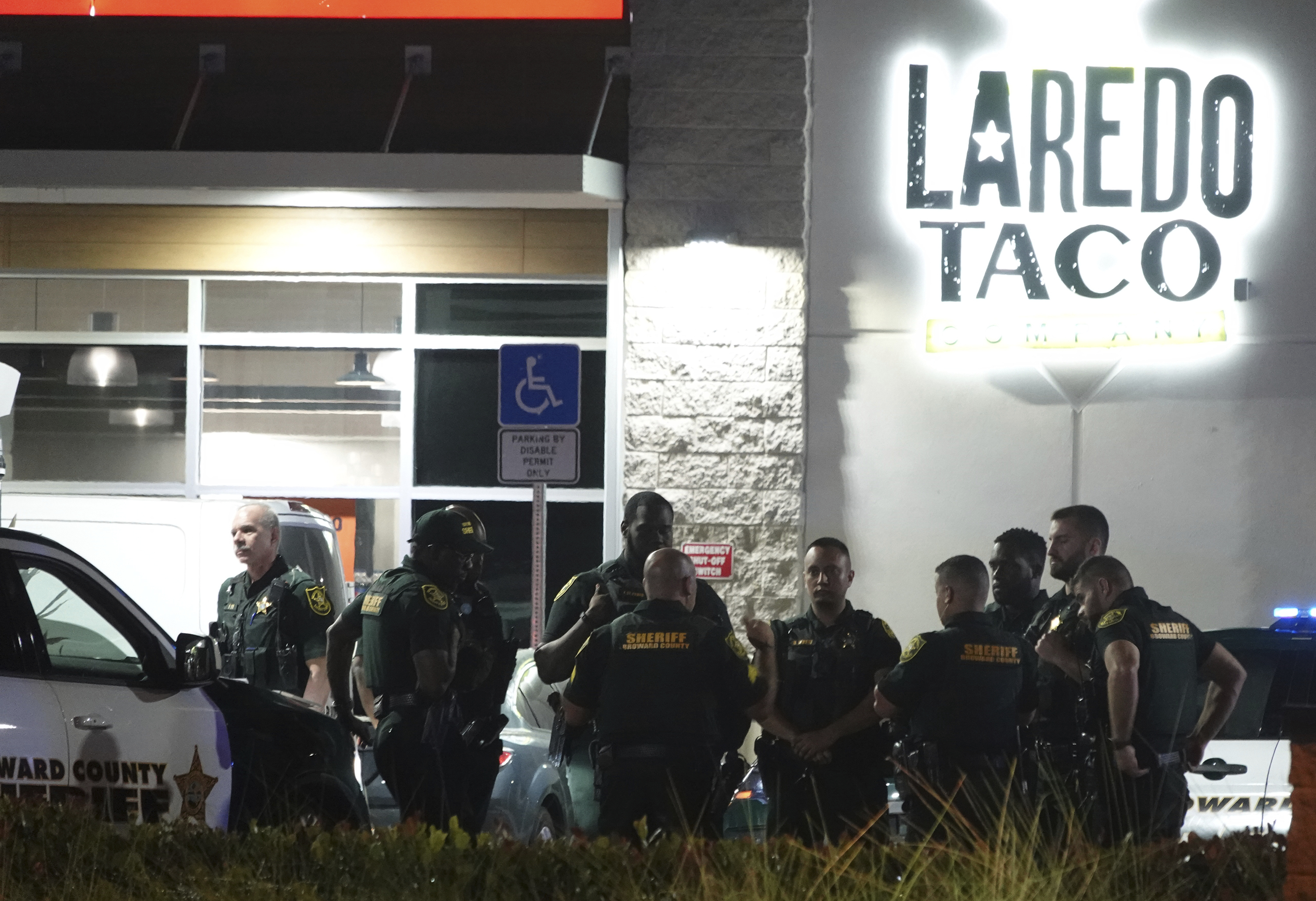 Broward Sheriff's Office deputies work the scene of a shooting in Dania Beach, Fla., Friday. A man fatally shot a 12-year-old boy and wounded another man before turning the gun on himself inside a South Florida gas station, sheriff's officials said.